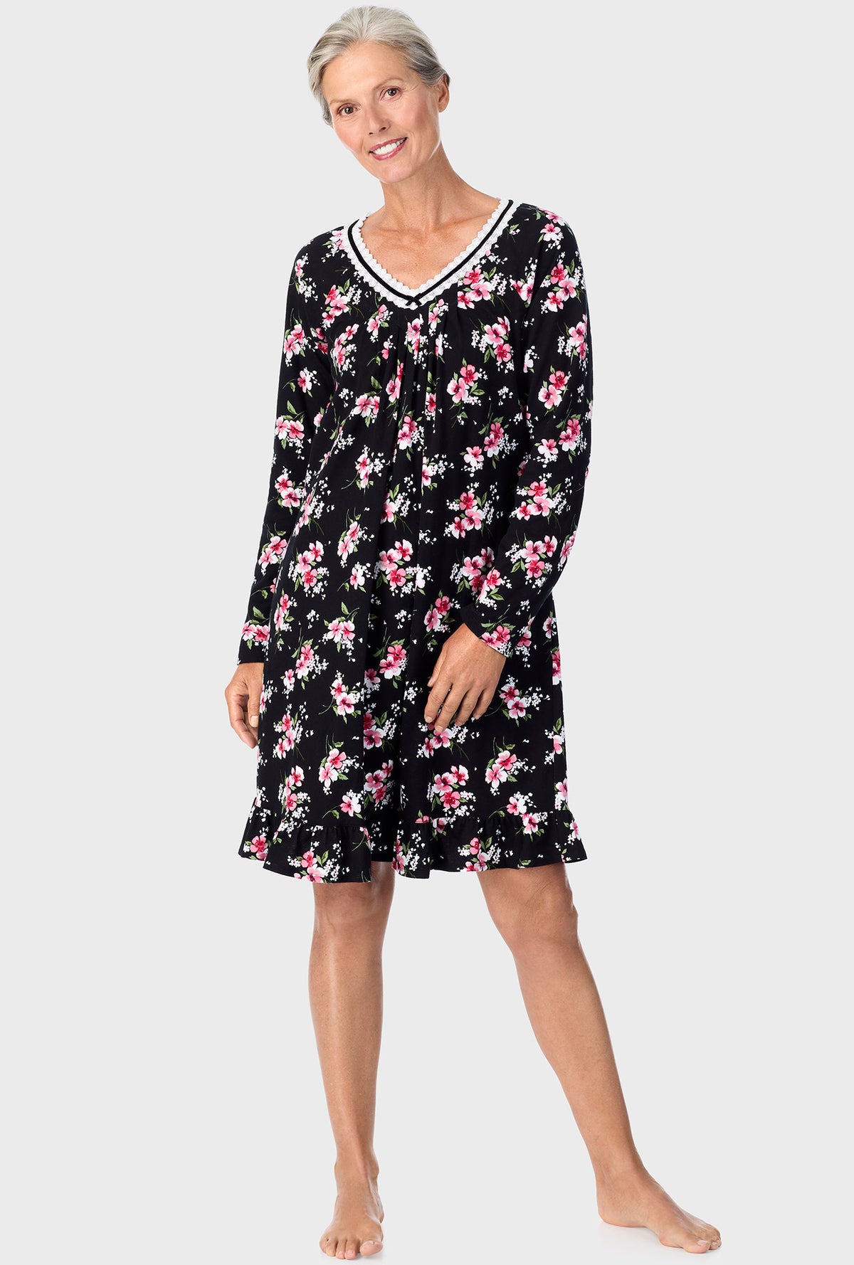 A lady wearing black long sleeve nightshirt with black floral print.