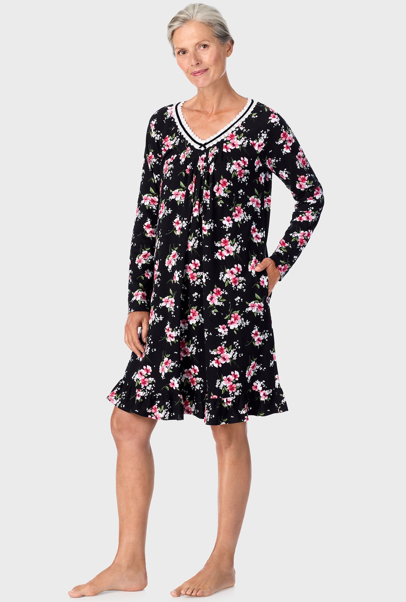 A lady wearing black long sleeve nightshirt with black floral print.