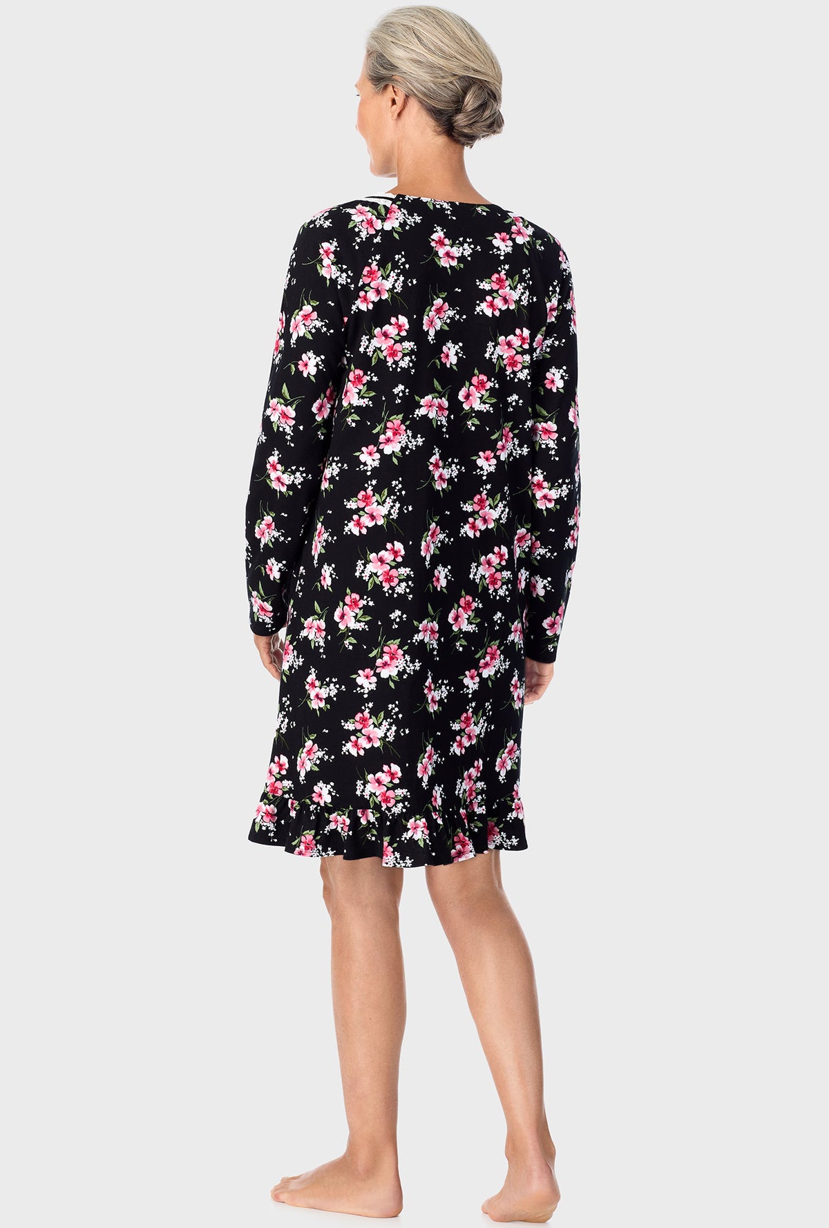 A lady wearing black long sleeve nightshirt with black floral print.