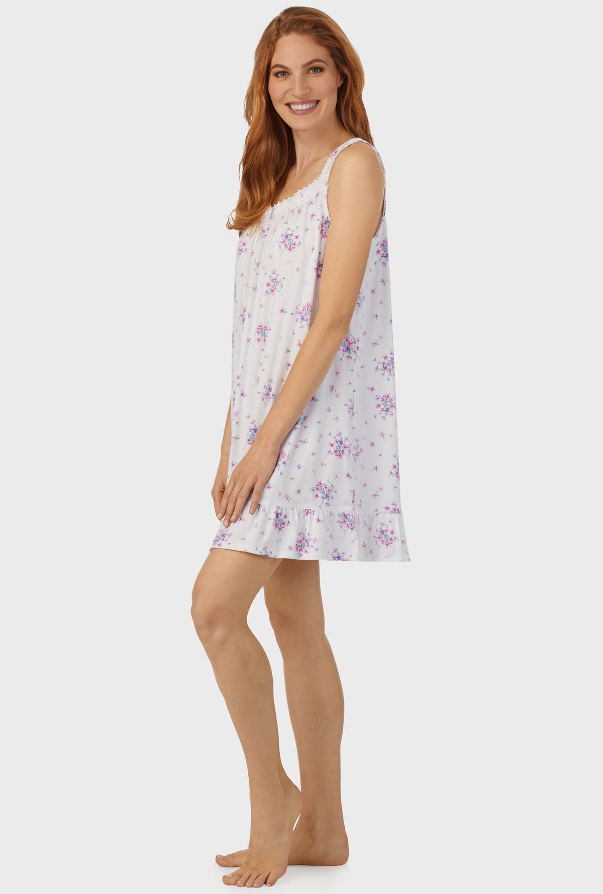 A lady wearing purple sleeveless chemise  with mulberry purple floral bouquet print.