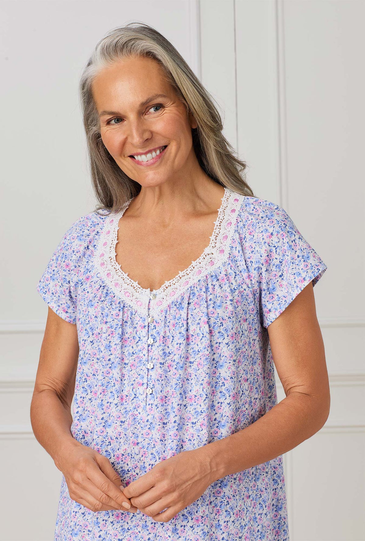 A lady wearing purple short sleeve nightgown with Lavender And Blush Ditsy Floral print.