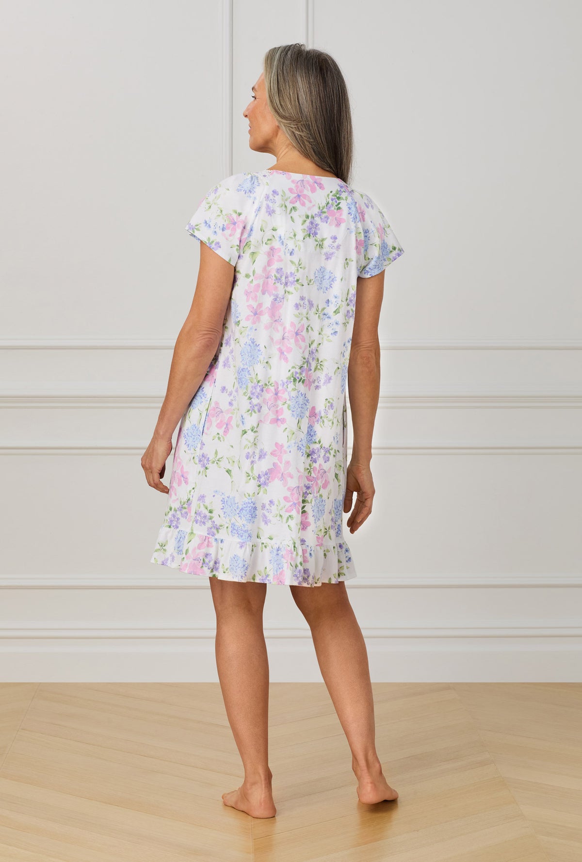 A lady wearing purple short sleeve Lilac and Periwinkle Garden Floral print.