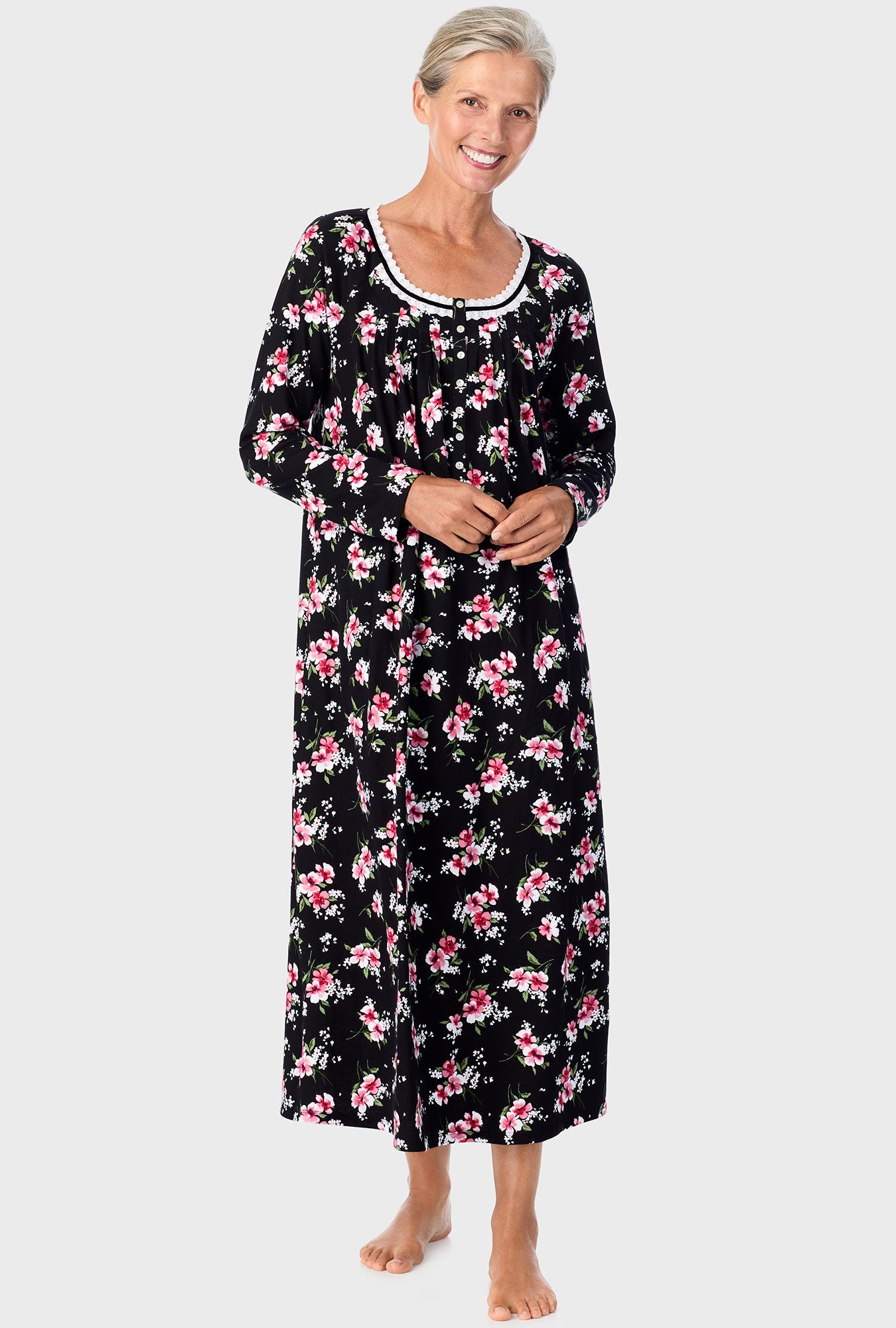 A lady wearing black long sleeve nightgown with black floral print.