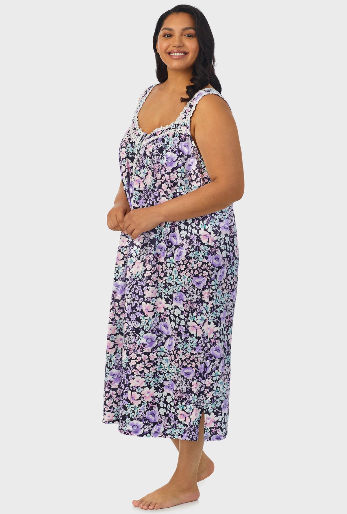 A lady wearing navy sleeveless ballet plus size gown with midnight blue floral print.