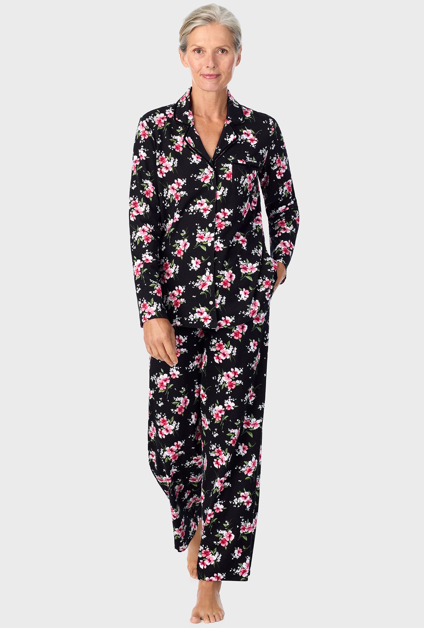 A lady wearing black long sleeve pj set with black floral print.