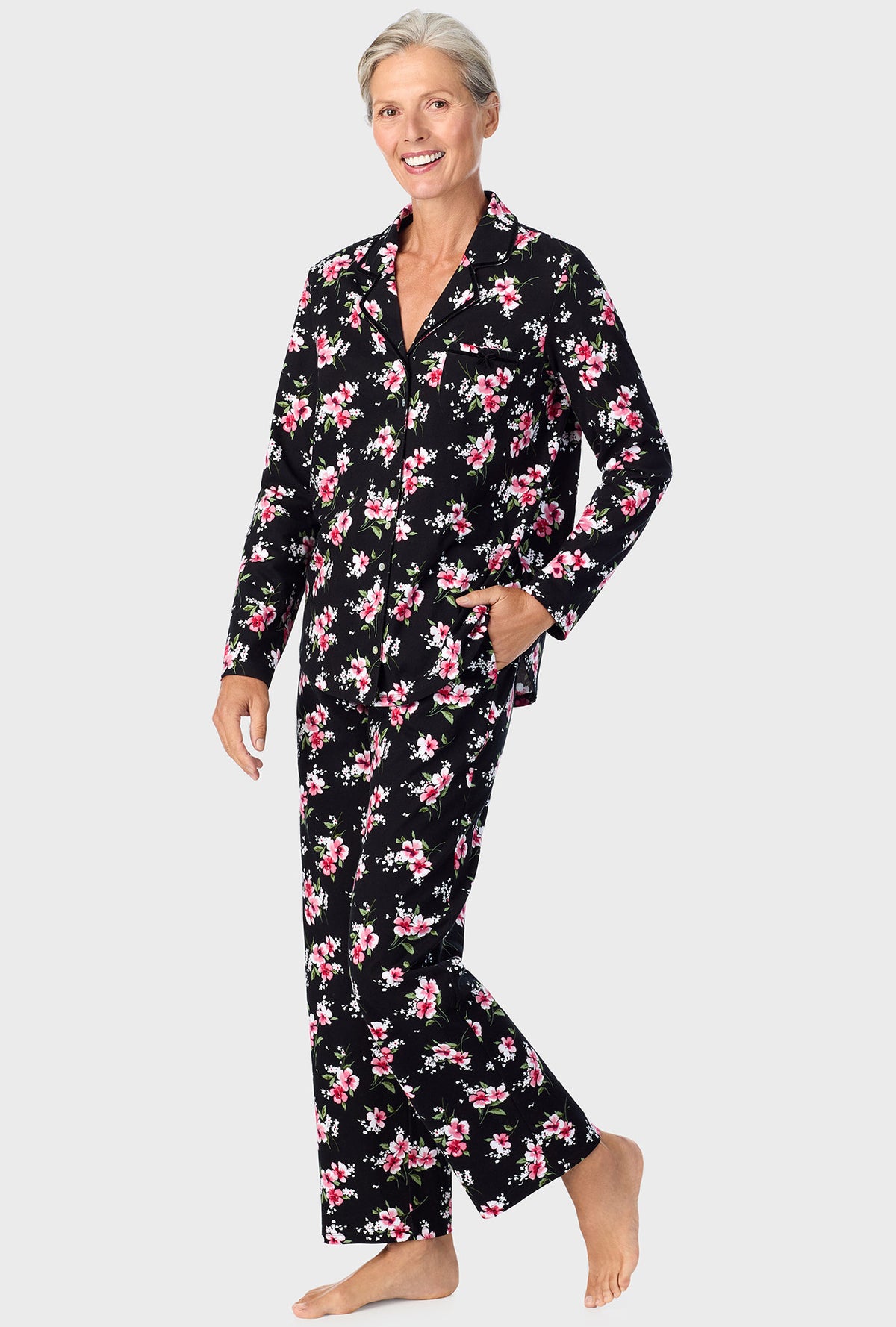 A lady wearing black long sleeve pj set with black floral print.