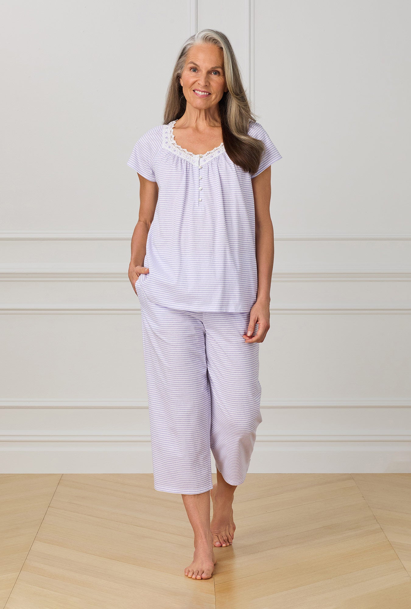 A lady wearing purple cap sleeve capri pant pj set with Lilac Stripe print.