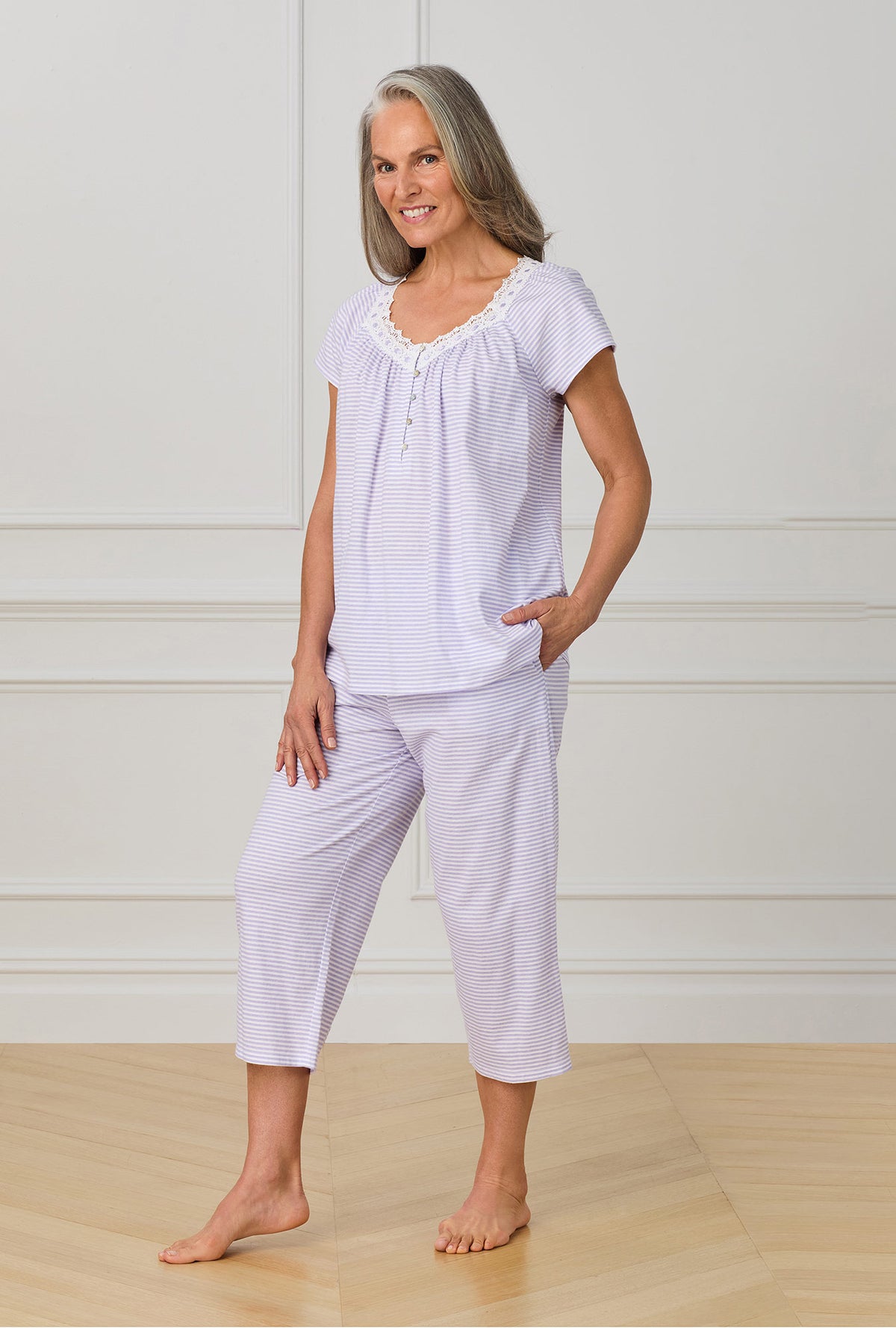 A lady wearing purple cap sleeve capri pant pj set with Lilac Stripe print.