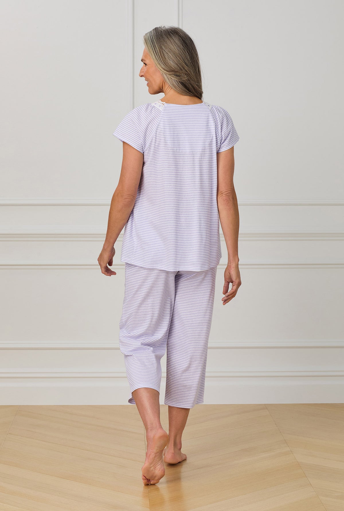 A lady wearing purple cap sleeve capri pant pj set with Lilac Stripe print.