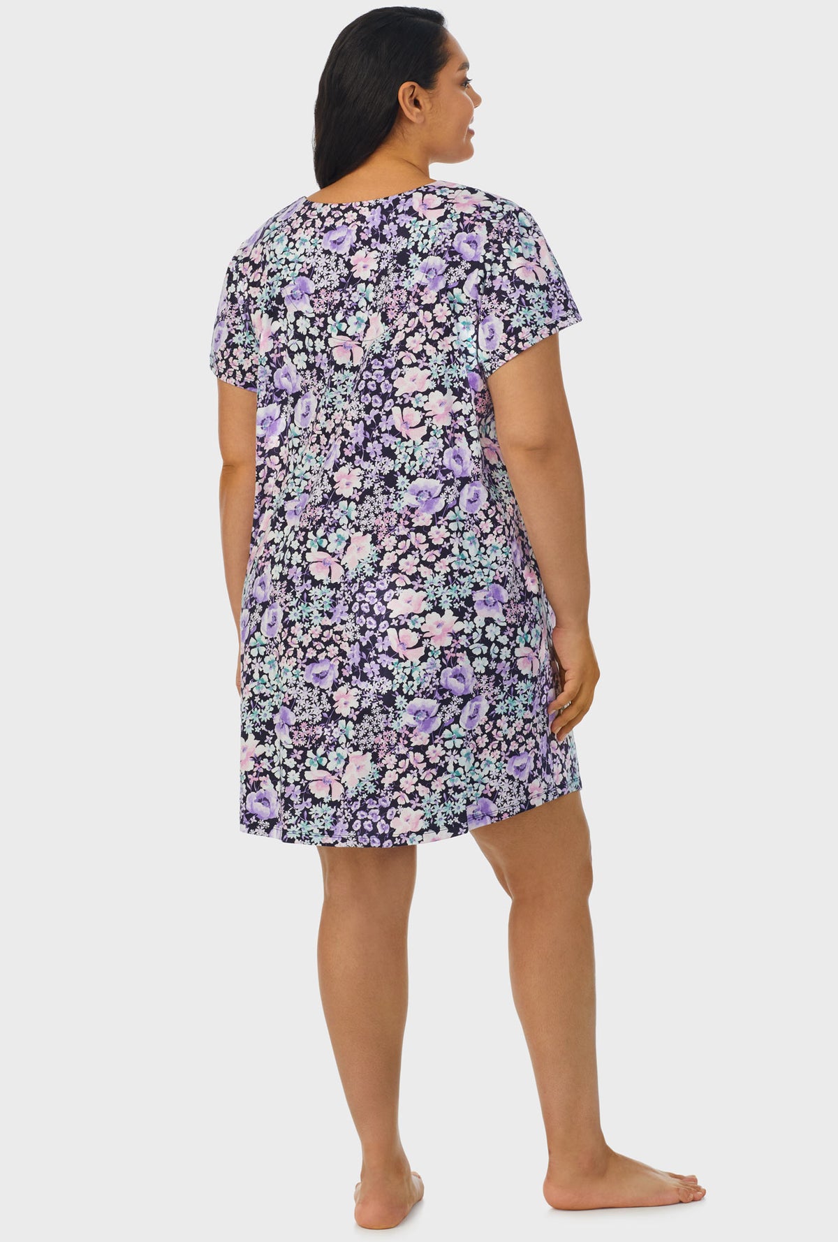 A lady wearing navy floral cap sleeve plus size nightshirt with midnight blue floral print.