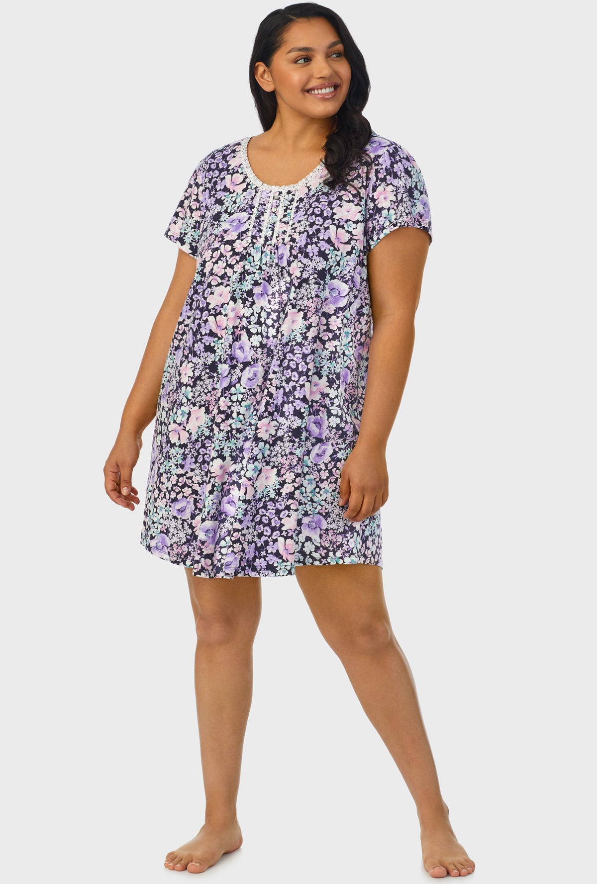 A lady wearing navy floral cap sleeve plus size nightshirt with midnight blue floral print.