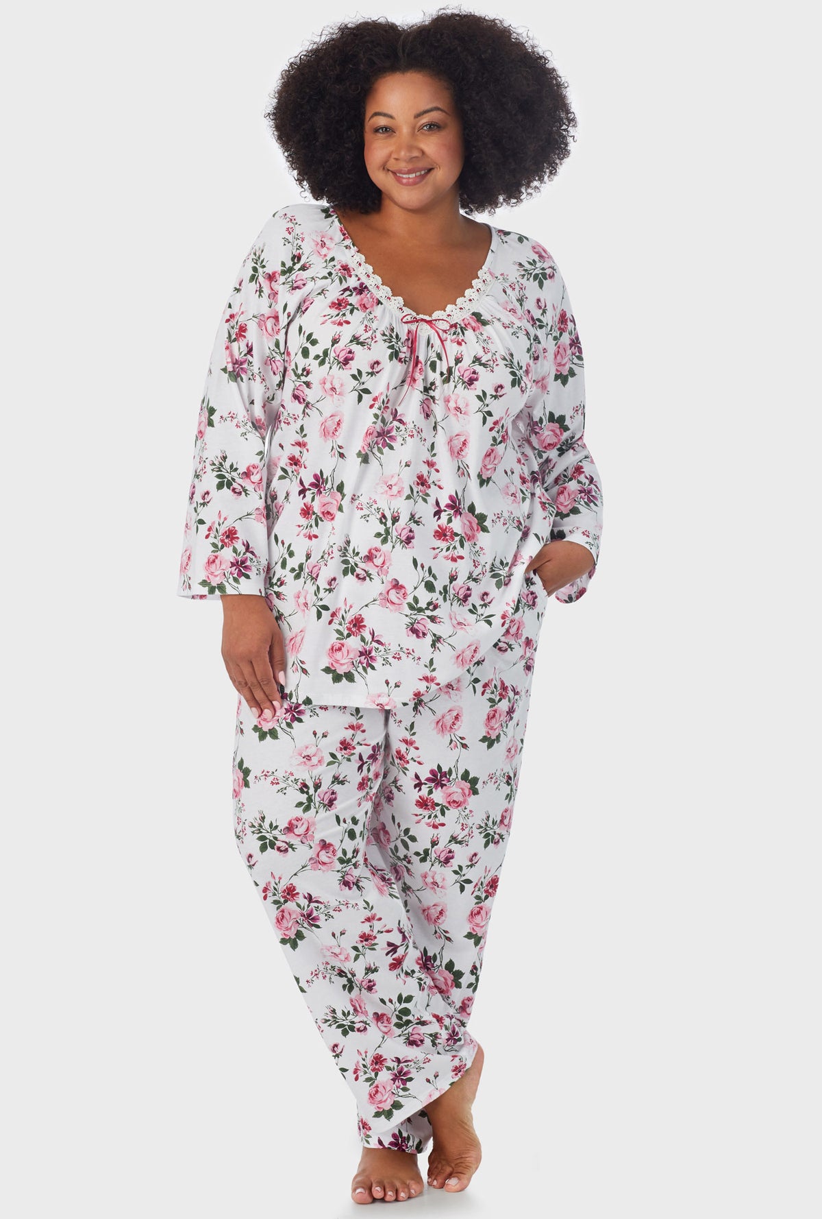 A lady wearing 3/4 Sleeve Long Pant plus size PJ Set with Pink and Berry Roses print