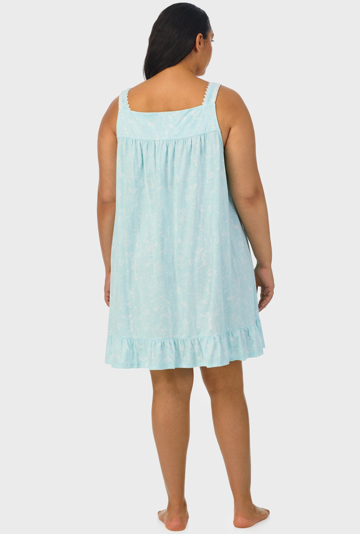 A lady wearing aqua sleeveless plus size chemise with scroll print.