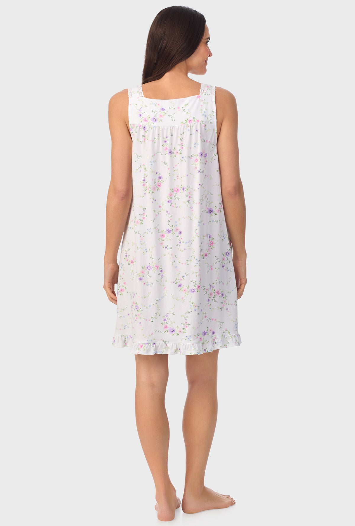 A lady wearing white sleeveless Viney Floral Sleeveless Chemise with Lilac and Cherry Blossom print