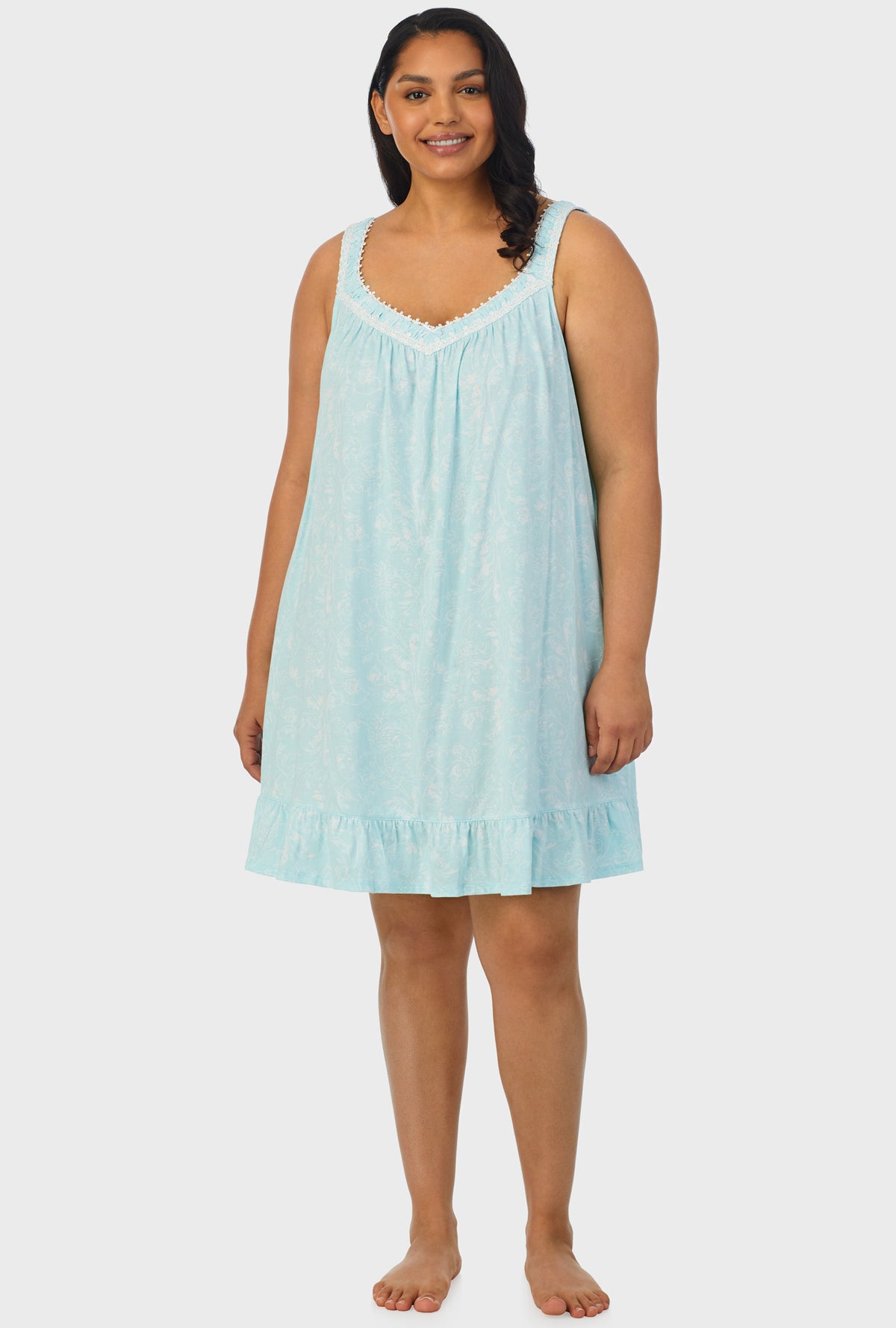 A lady wearing aqua sleeveless plus size chemise with scroll print.