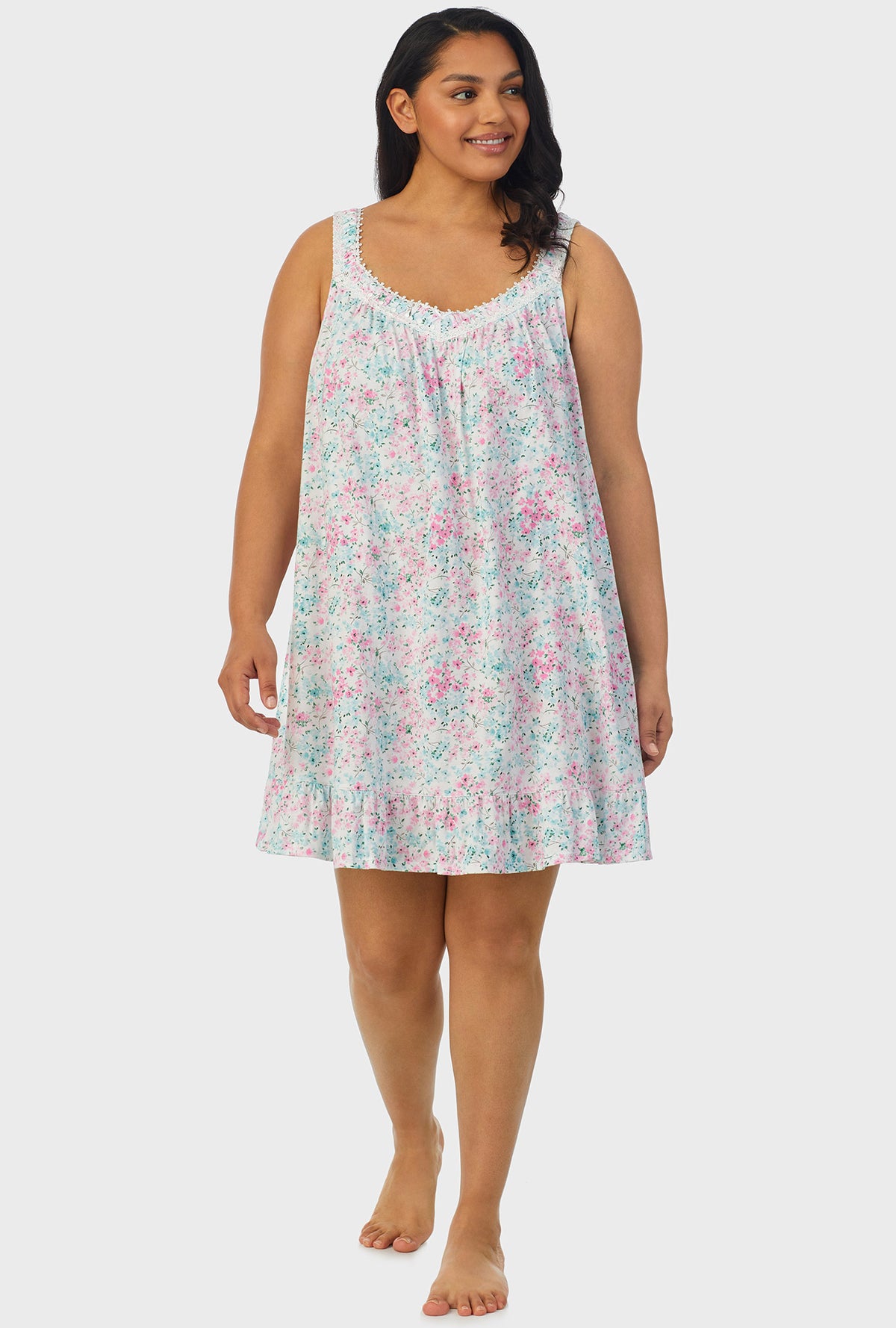 A lady wearing multi color sleeveless plus size chemise with aqua and pink floral print.