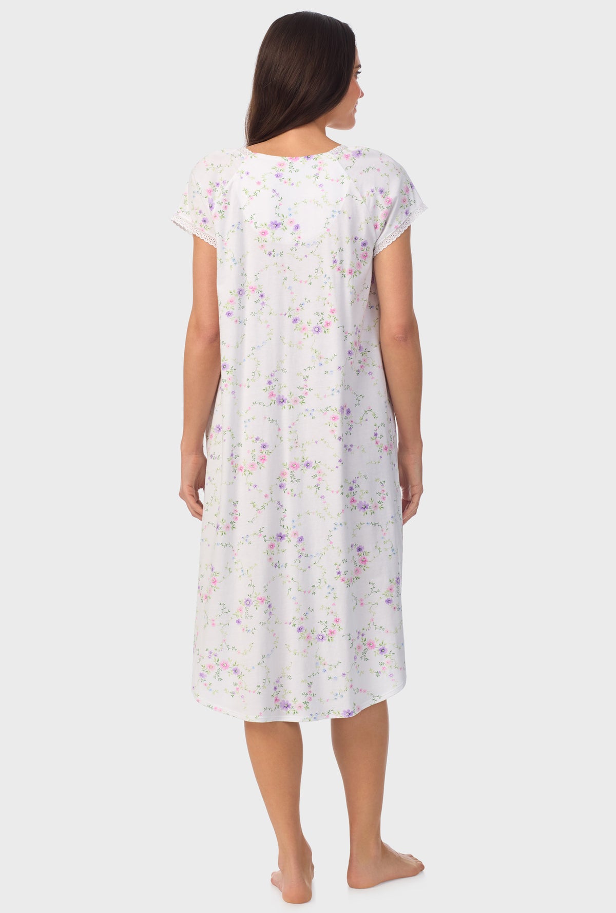 A lady wearing white short sleeve Viney Floral Cap Sleeve Nightgown with Lilac and Cherry Blossom print