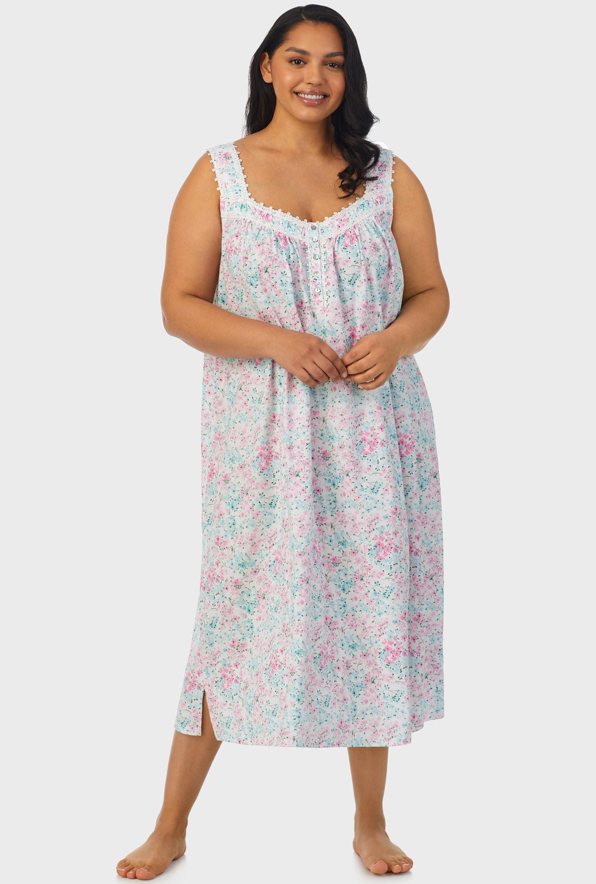 A lady wearing multi color sleeveless ballet plus size gown with aqua and pink floral print.