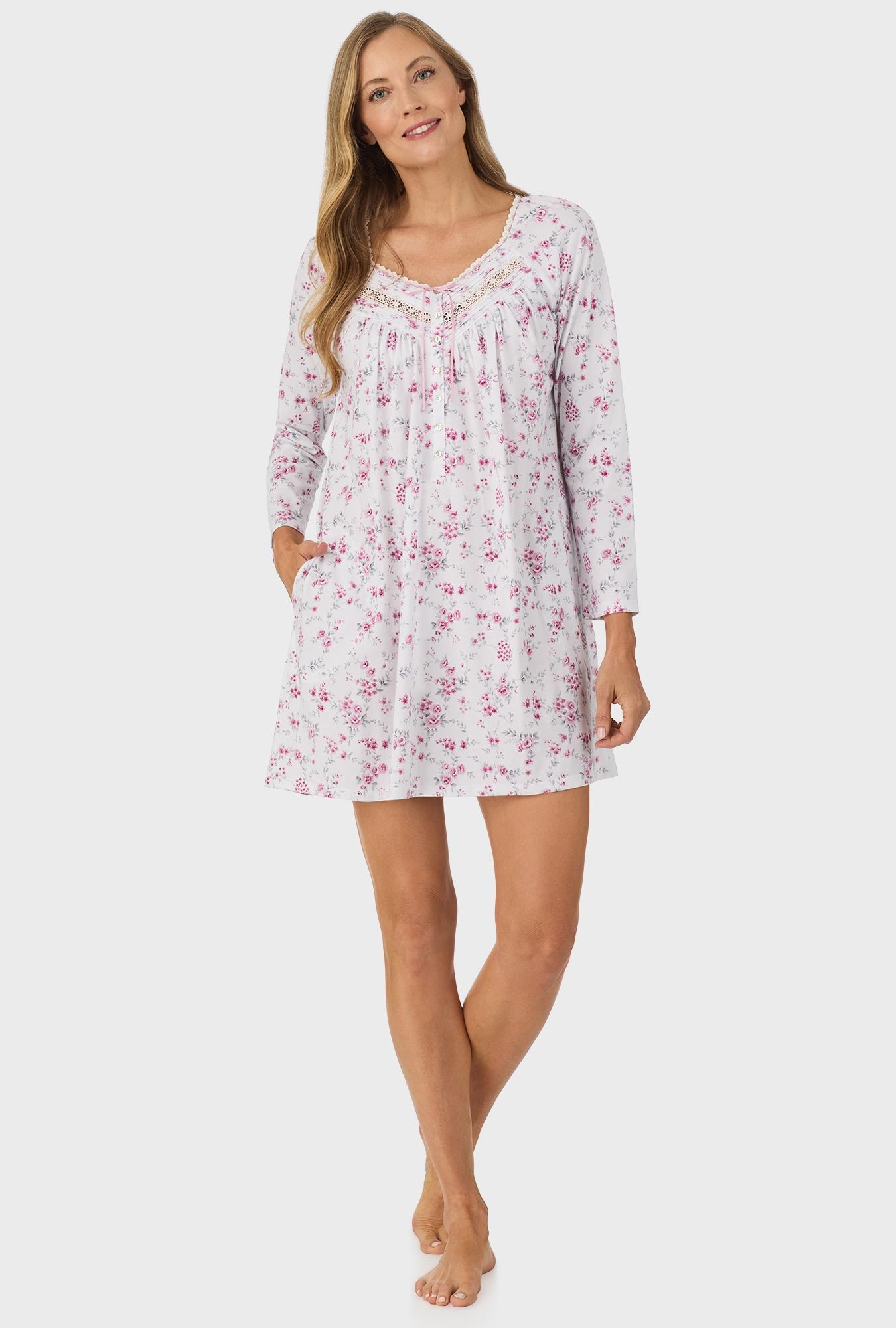 A lady wearing pink long sleeve nightgown with pink floral print.