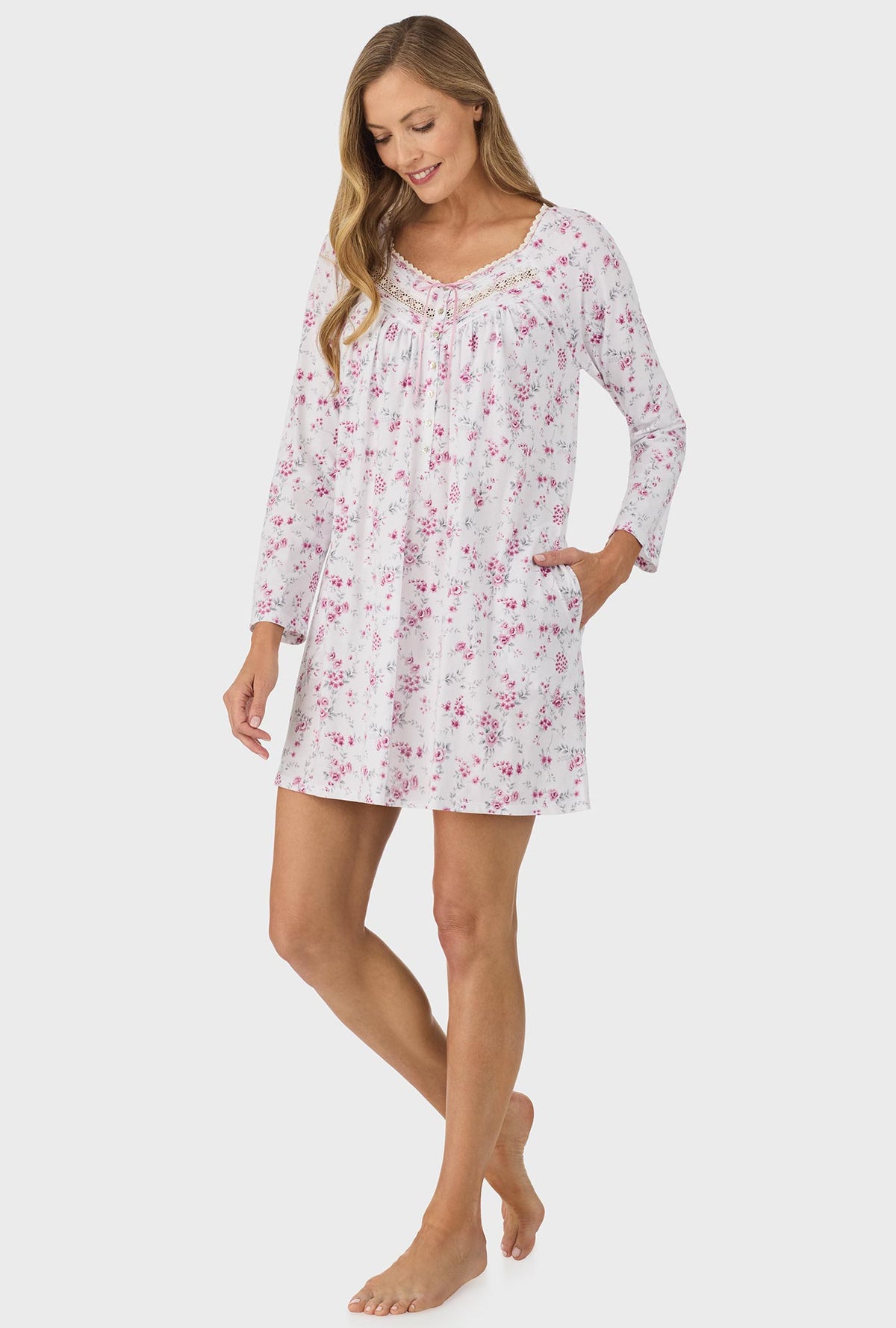 A lady wearing pink long sleeve nightgown with pink floral print.