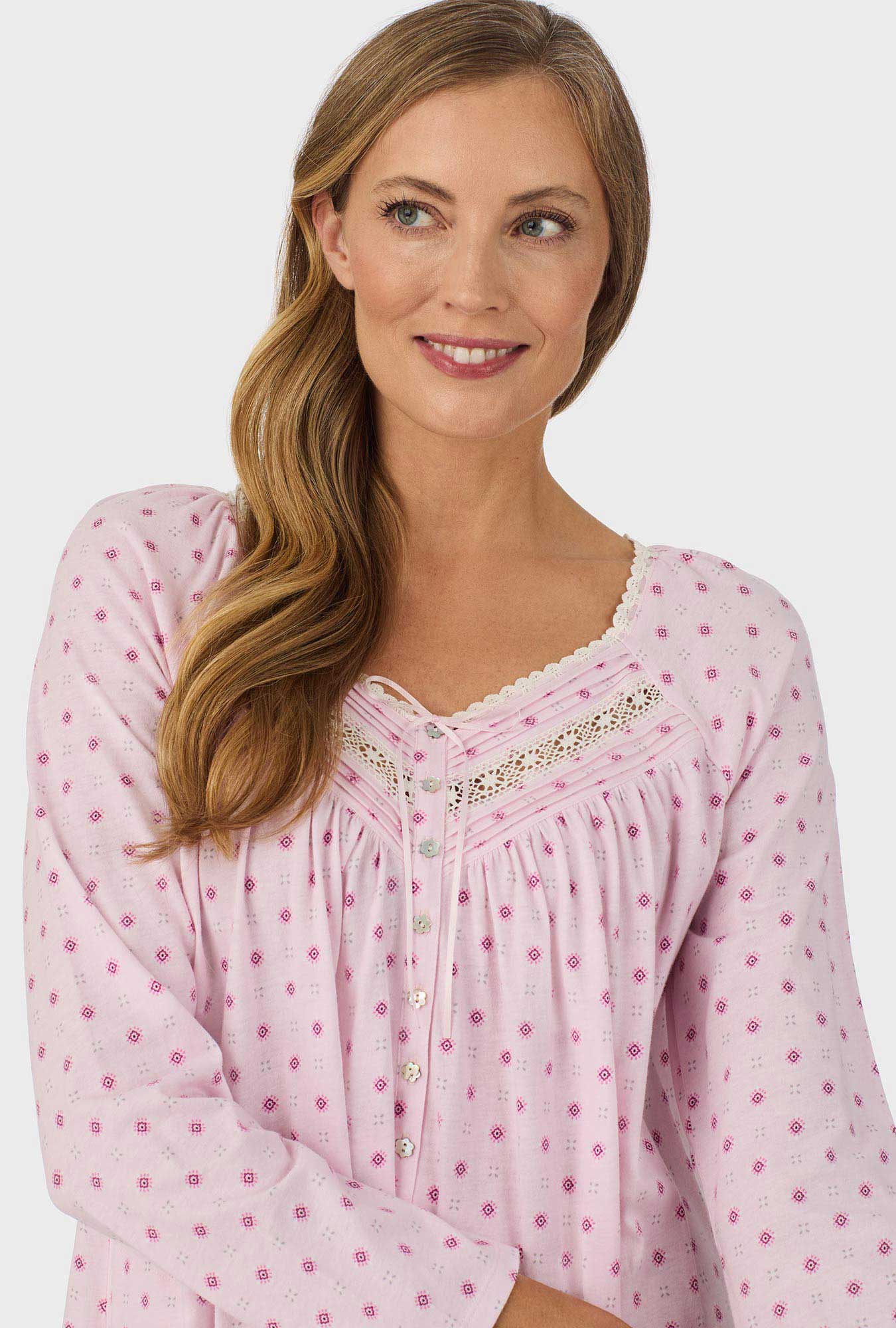 A lady wearing pink long sleeve cotton candy nightgown with pink geo print.