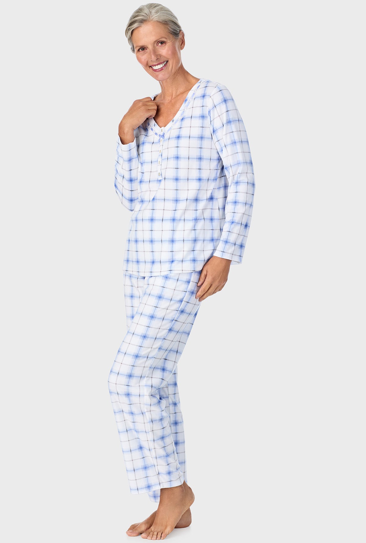 A lady wearing blue long sleeve Henley  pj set with blue bell plaid print.