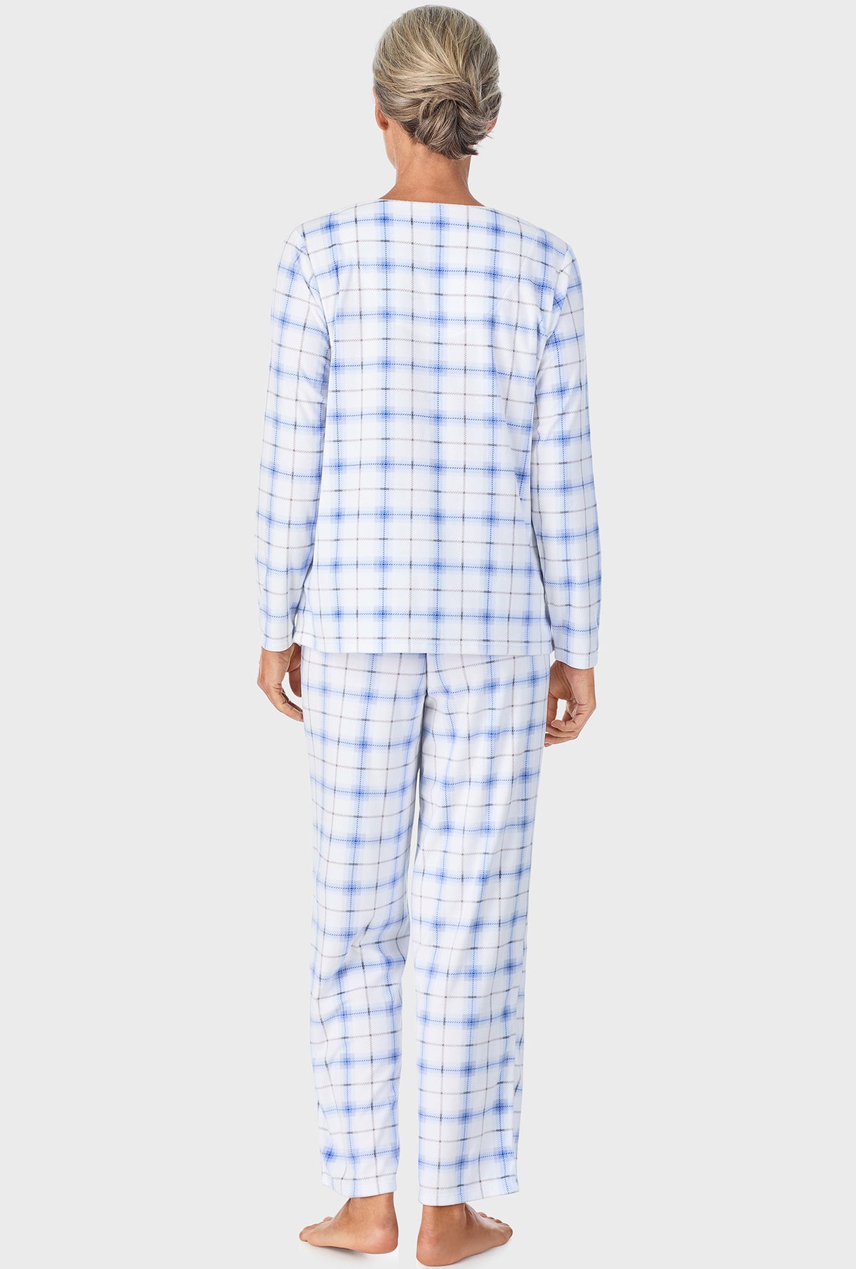 A lady wearing blue long sleeve Henley  pj set with blue bell plaid print.