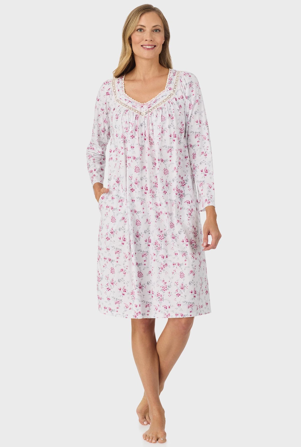 A lady wearing pink long sleeve nightgown with pink floral print.