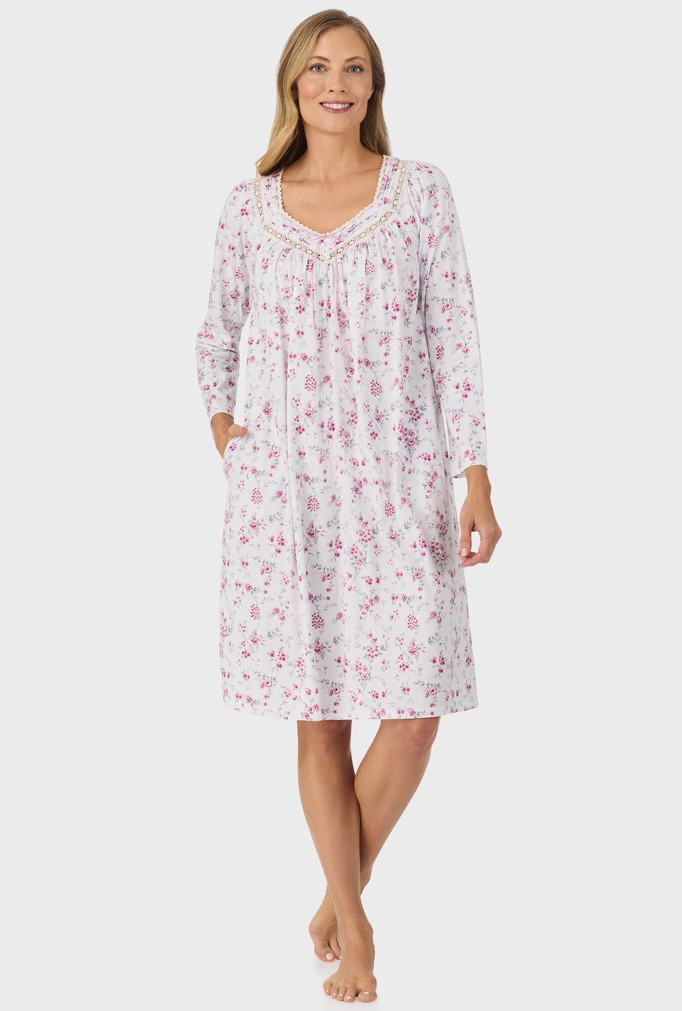 A lady wearing pink long sleeve nightgown with pink floral print.