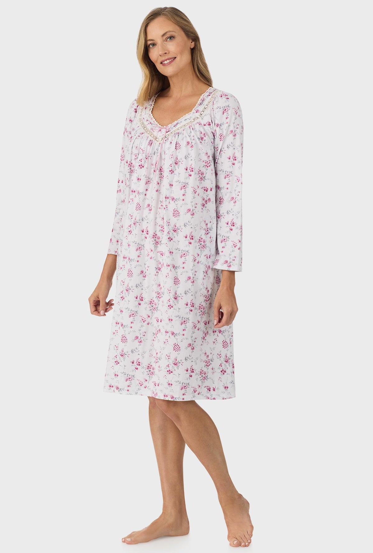 A lady wearing pink long sleeve nightgown with pink floral print.