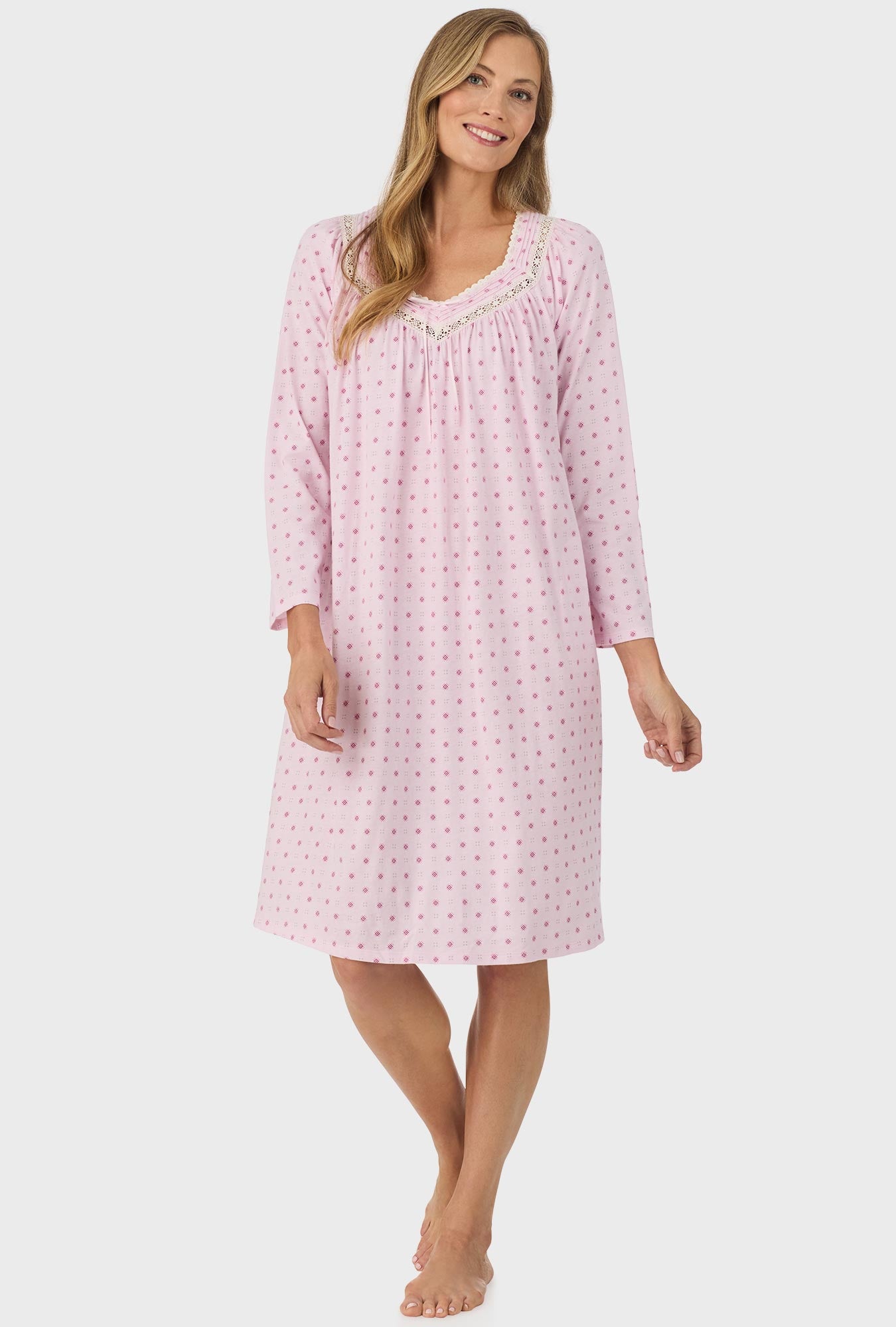 A lady wearing pink long sleeve cotton candy nightgown with pink geo print.