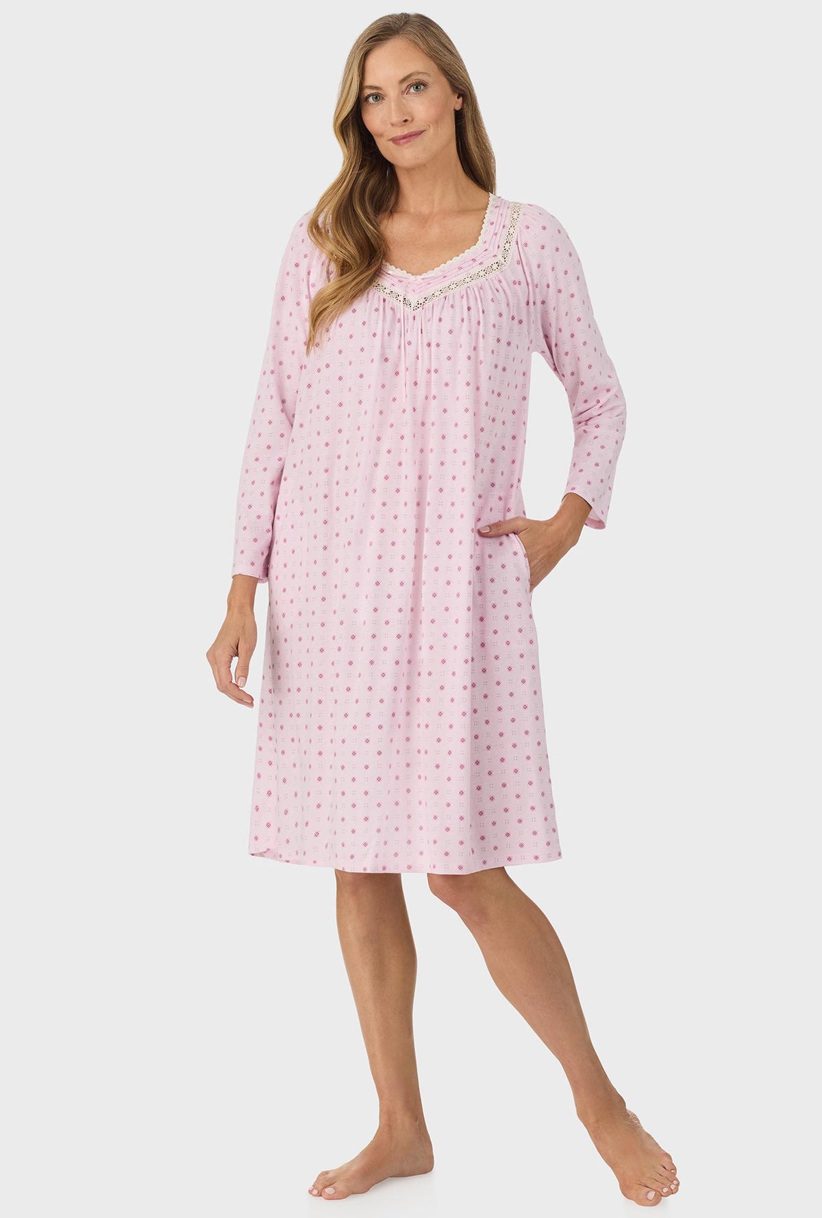 A lady wearing pink long sleeve cotton candy nightgown with pink geo print.