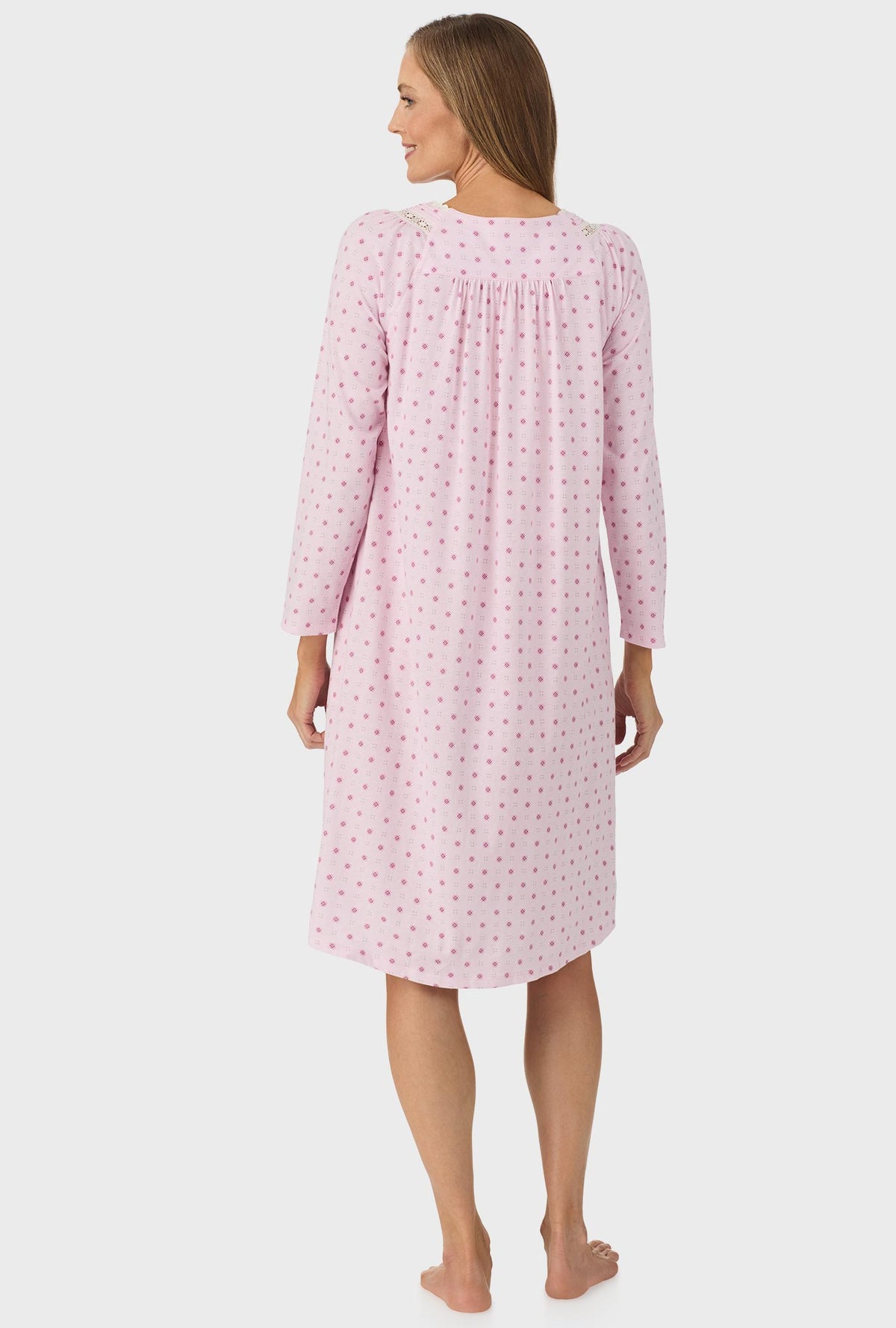 A lady wearing pink long sleeve cotton candy nightgown with pink geo print.