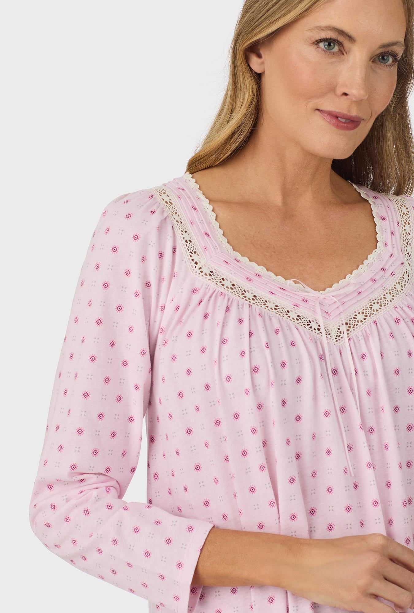 A lady wearing pink long sleeve cotton candy nightgown with pink geo print.