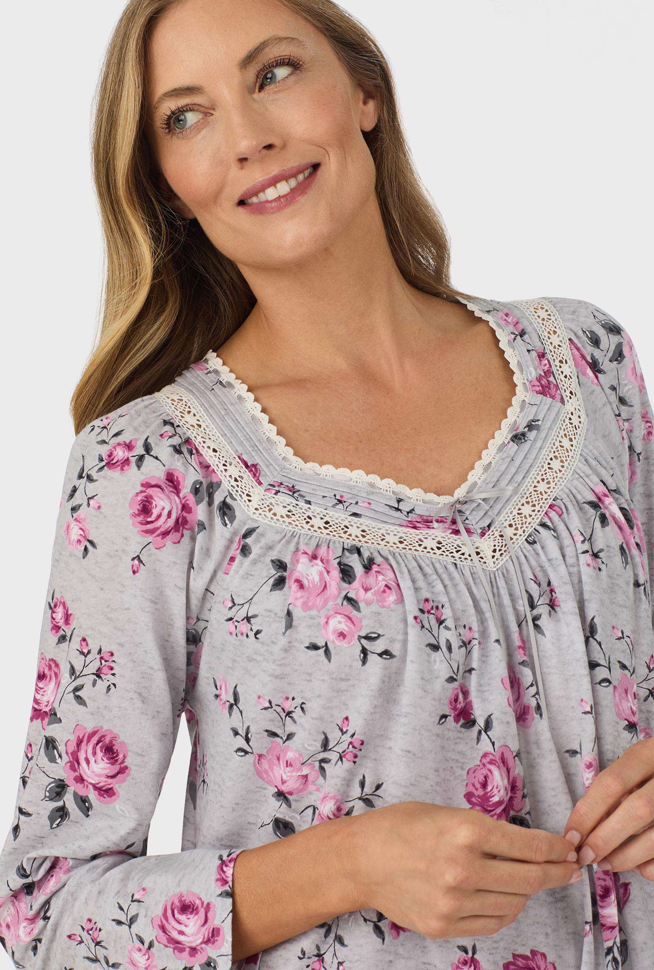 A lady wearing grey long sleeve nightgown with heather garden roses print.