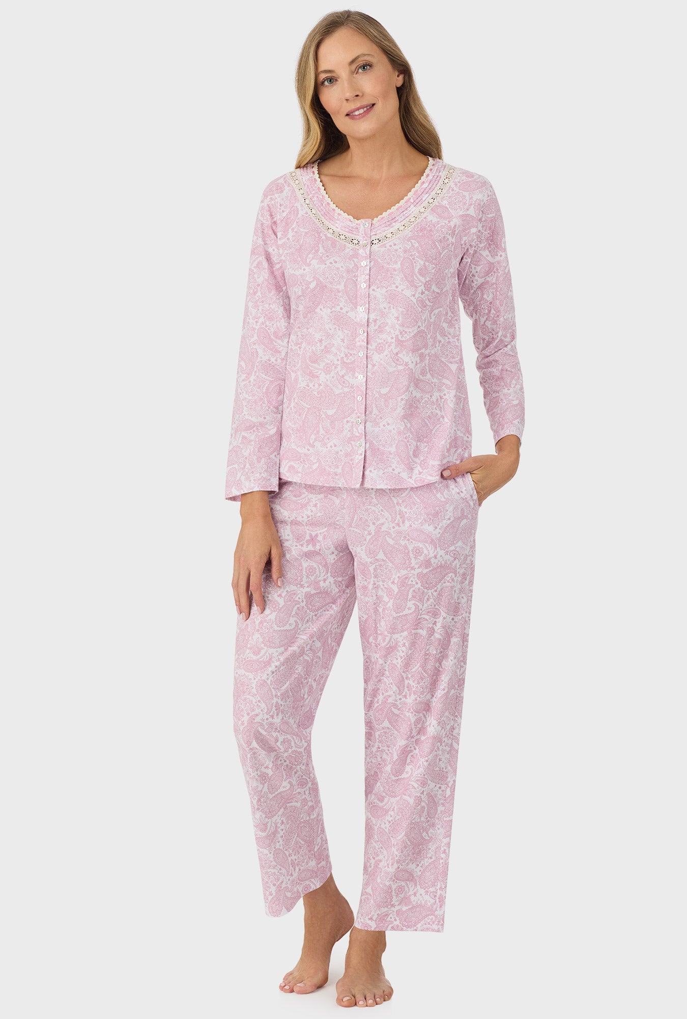 A lady wearing pink long sleeve long pant pj set with pink paisley print.