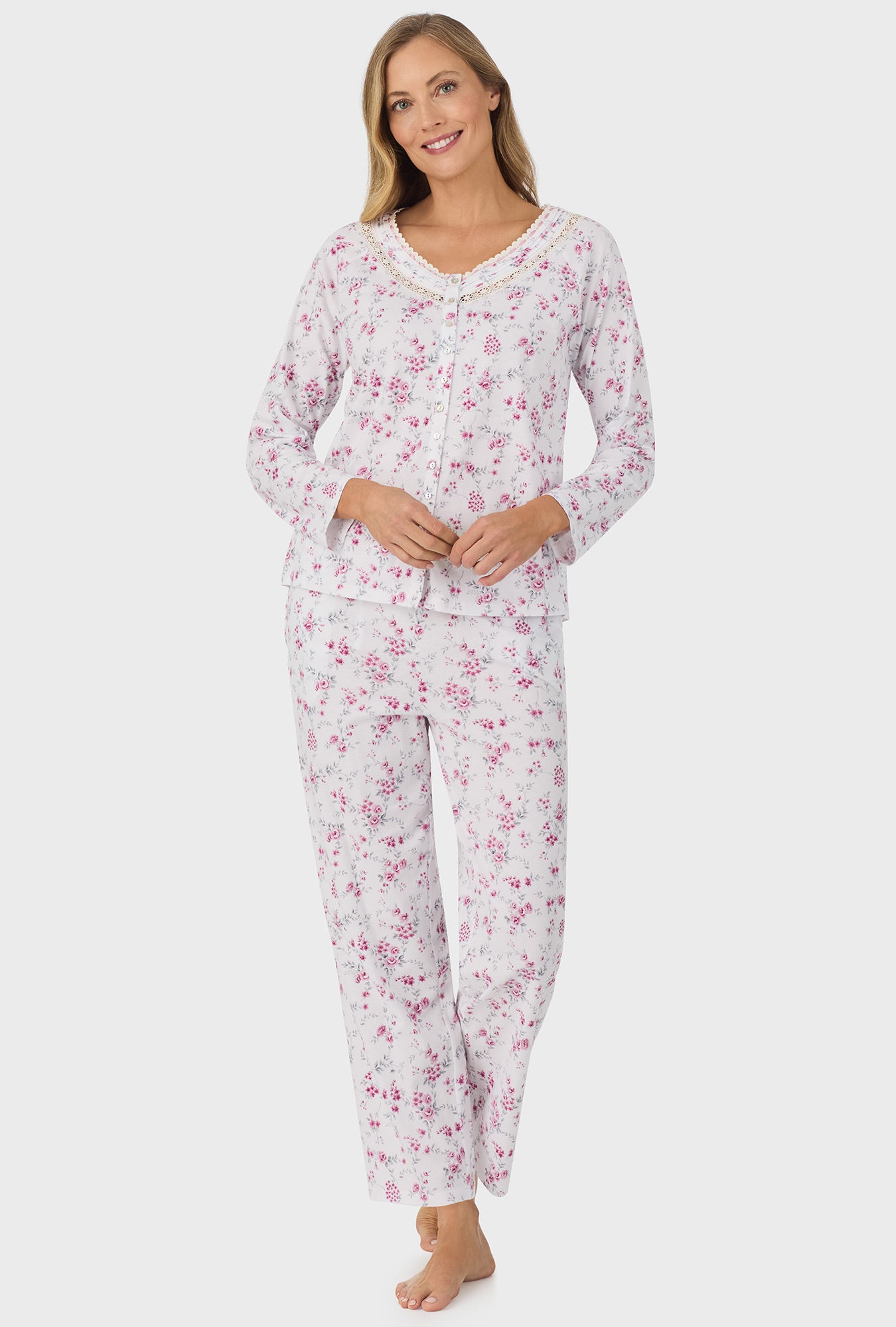 A lay wearing pink long sleeve long pant pj set with pink floral print.