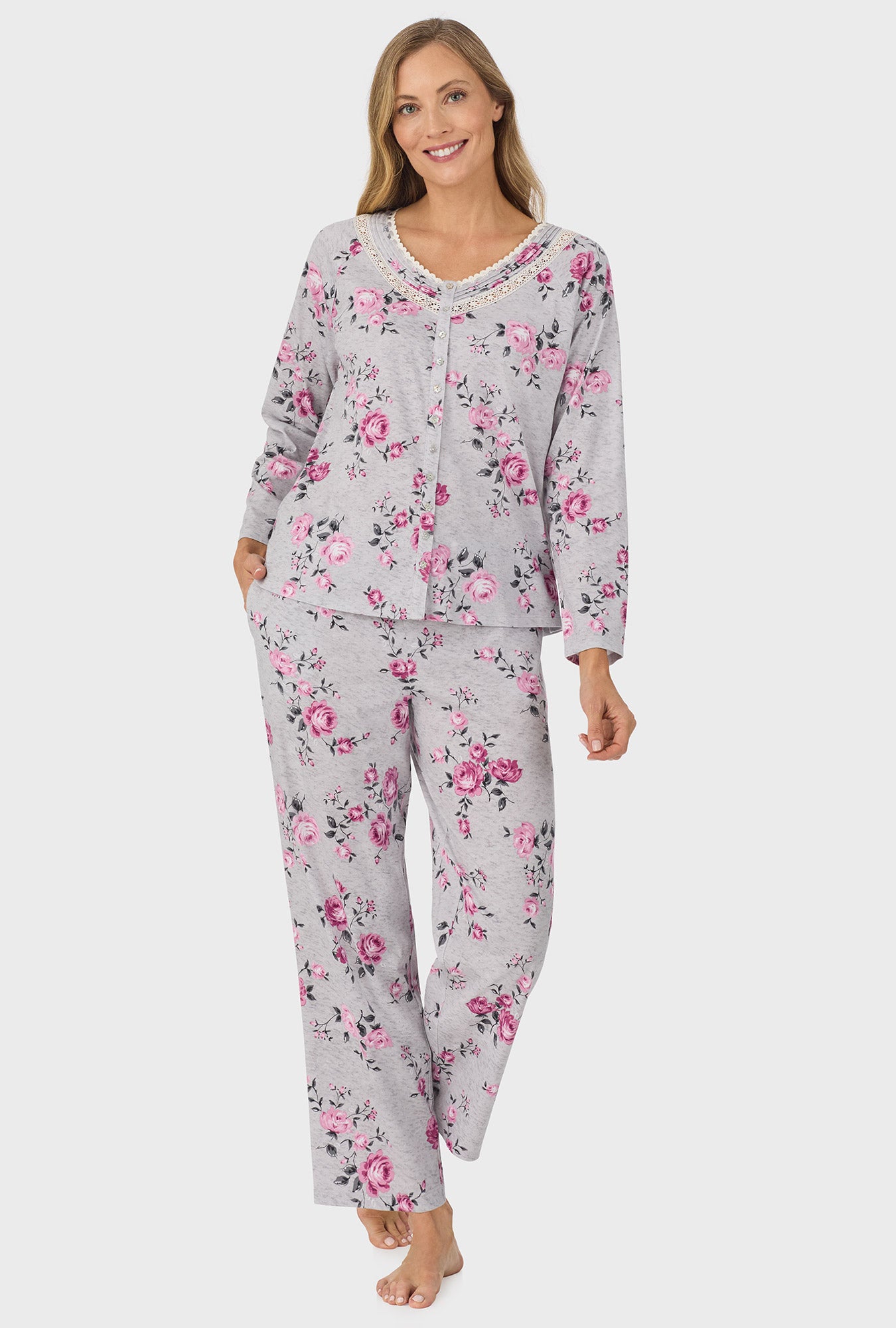 A lady wearing grey long sleeve long pant pj set with heather garden roses print.