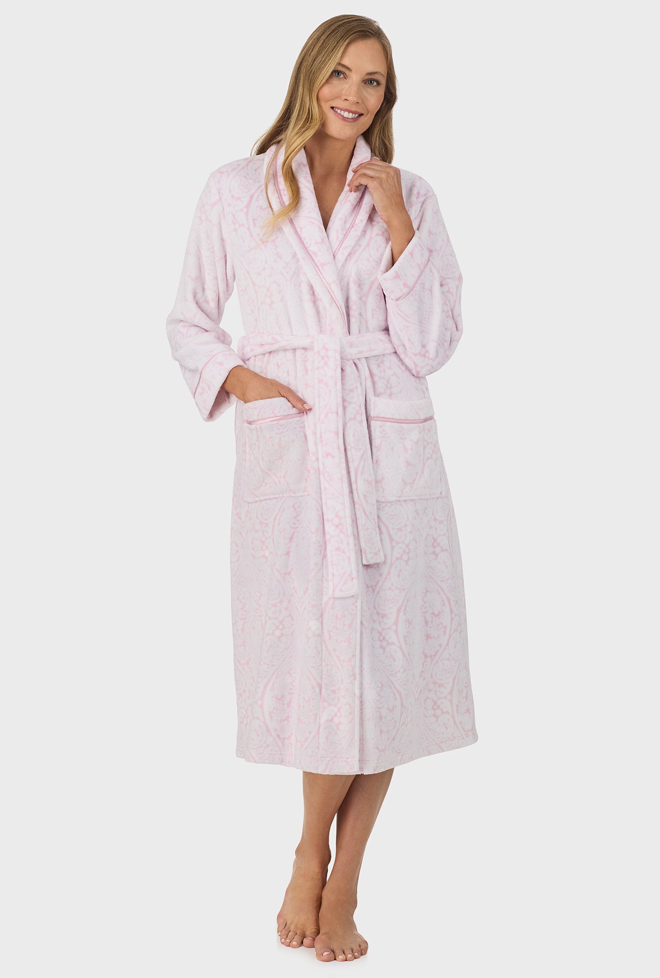 A lady wearing pink long sleeve wrap robe with fairytale pink damask scroll print.