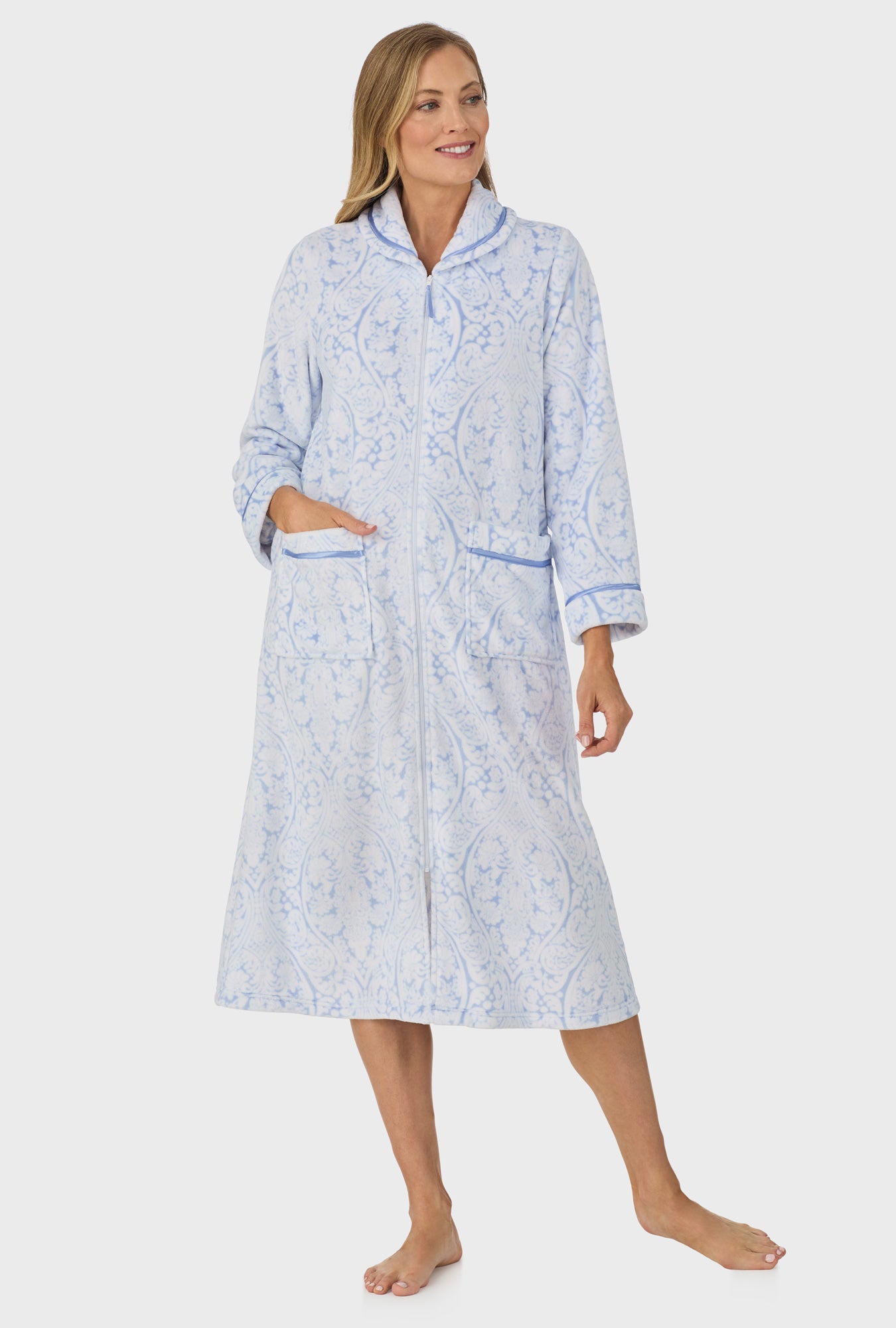 A lady wearing blue long sleeve zipper robe with malibu damask print.