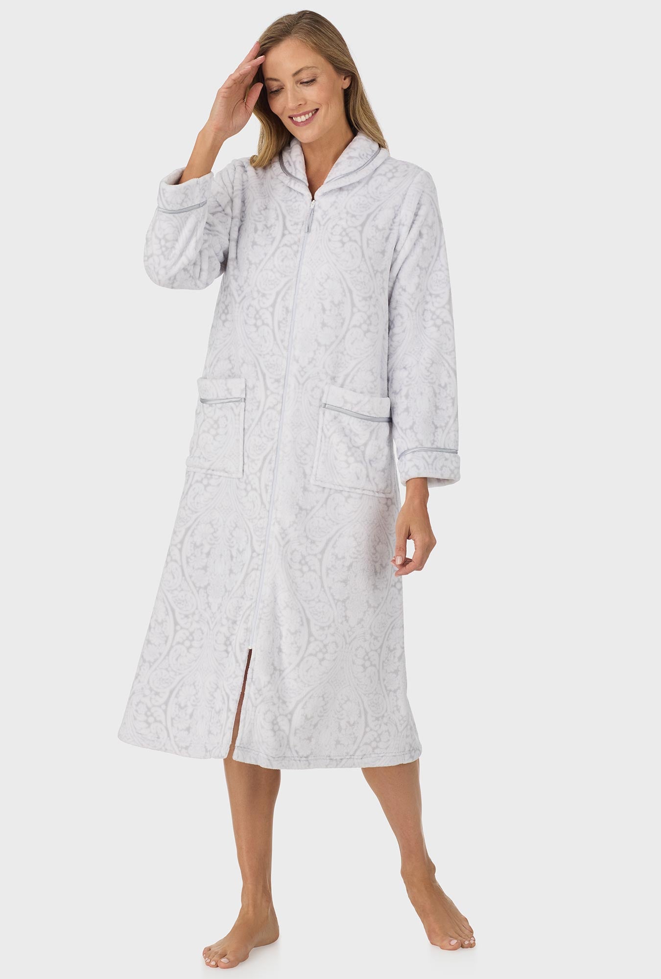 A lady wearing grey long sleeve zipper robe with white grey damask scroll print.