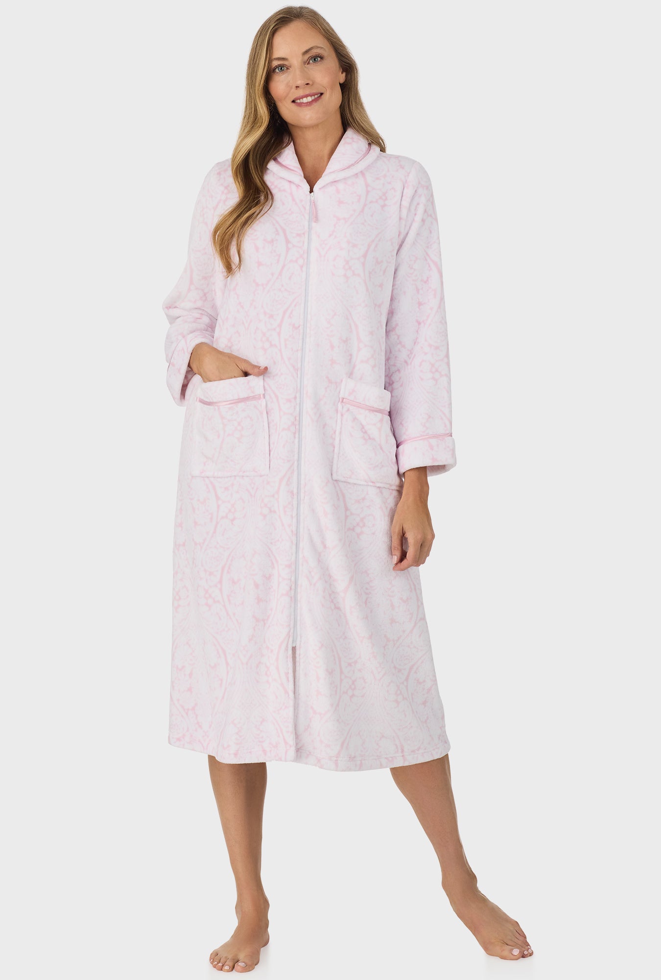 A lady wearing pink zipper robe with fairytale pink damask print.