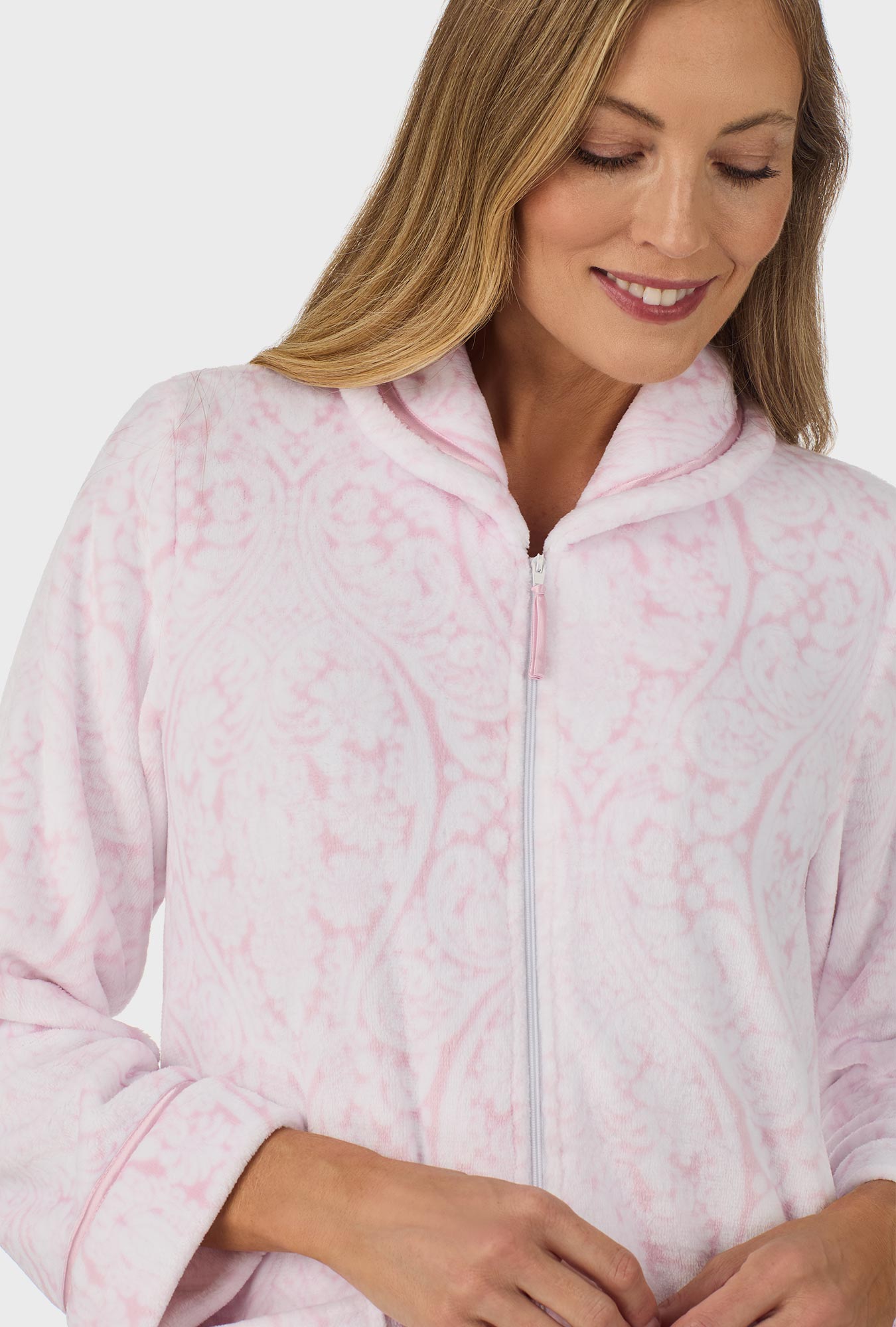 A lady wearing pink zipper robe with fairytale pink damask print.