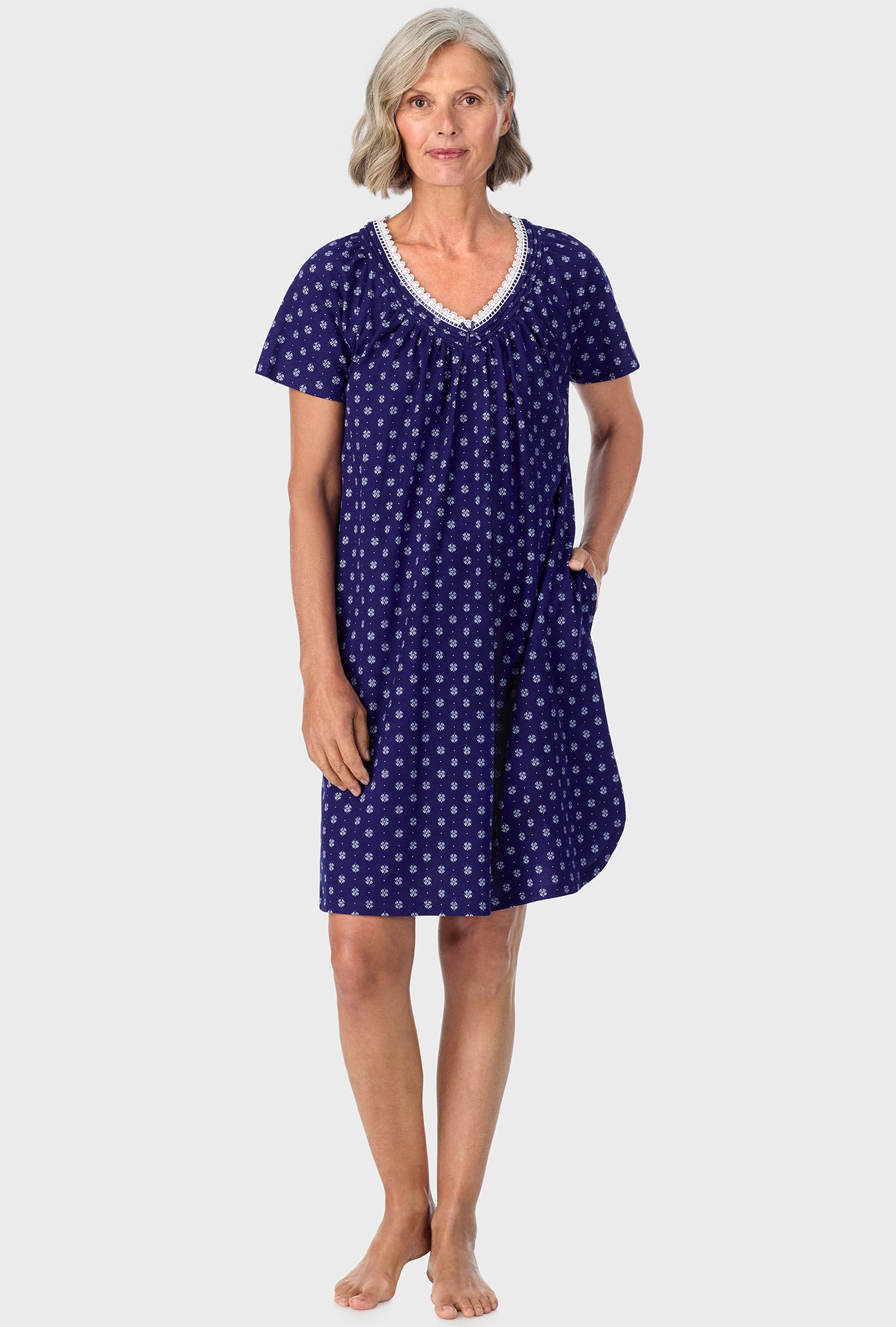 A lady wearing navy short sleeve sleepshirt with navy geo print.