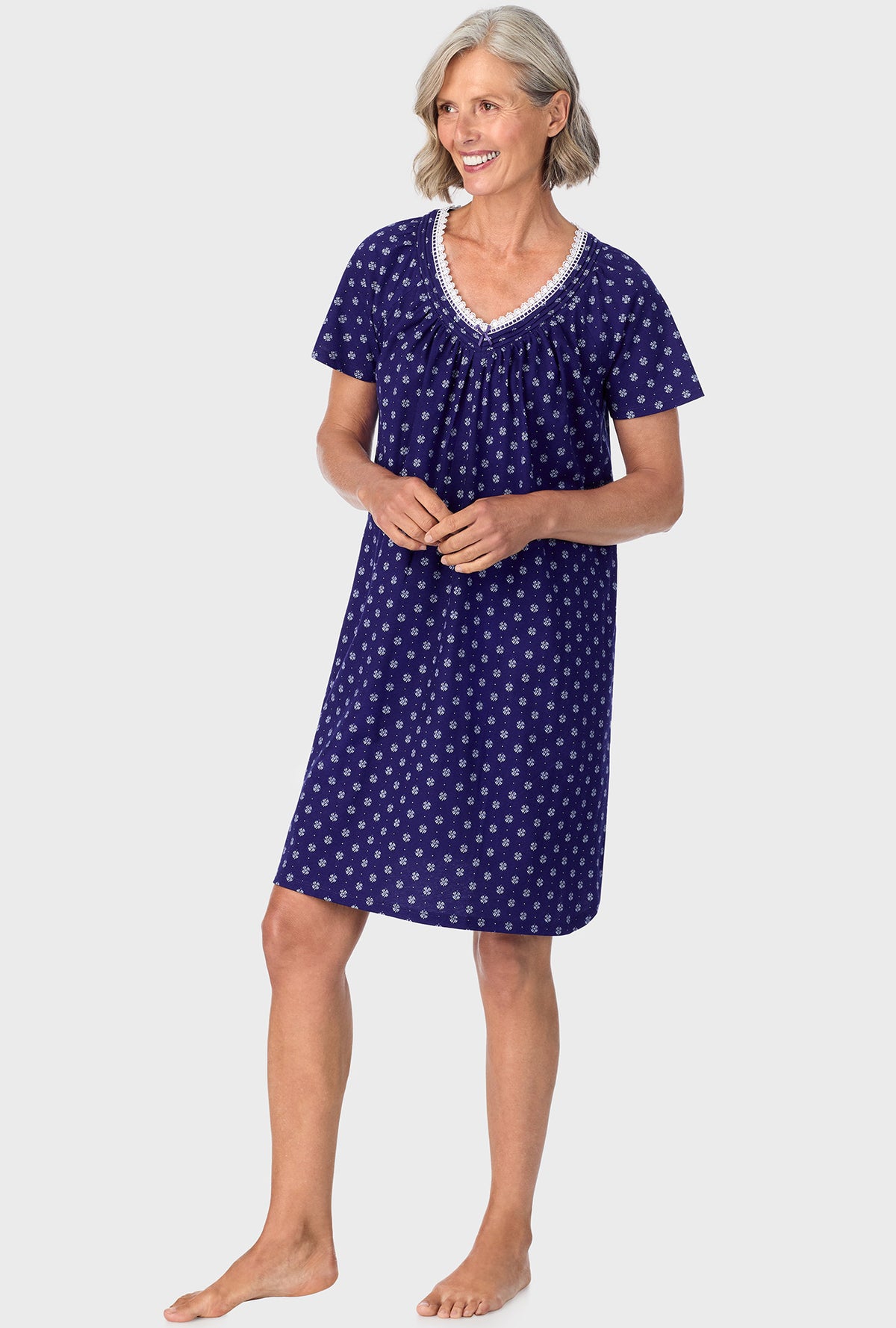 A lady wearing navy short sleeve sleepshirt with navy geo print.