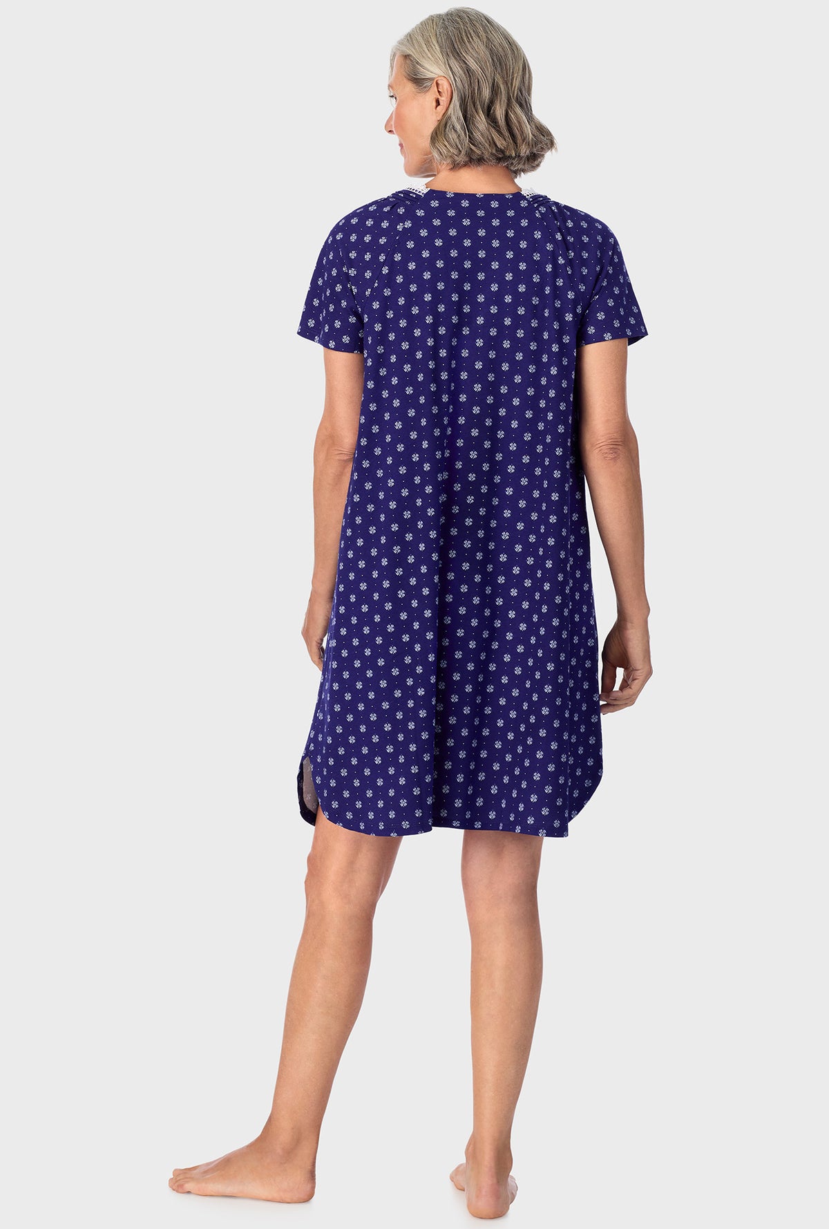 A lady wearing navy short sleeve sleepshirt with navy geo print.