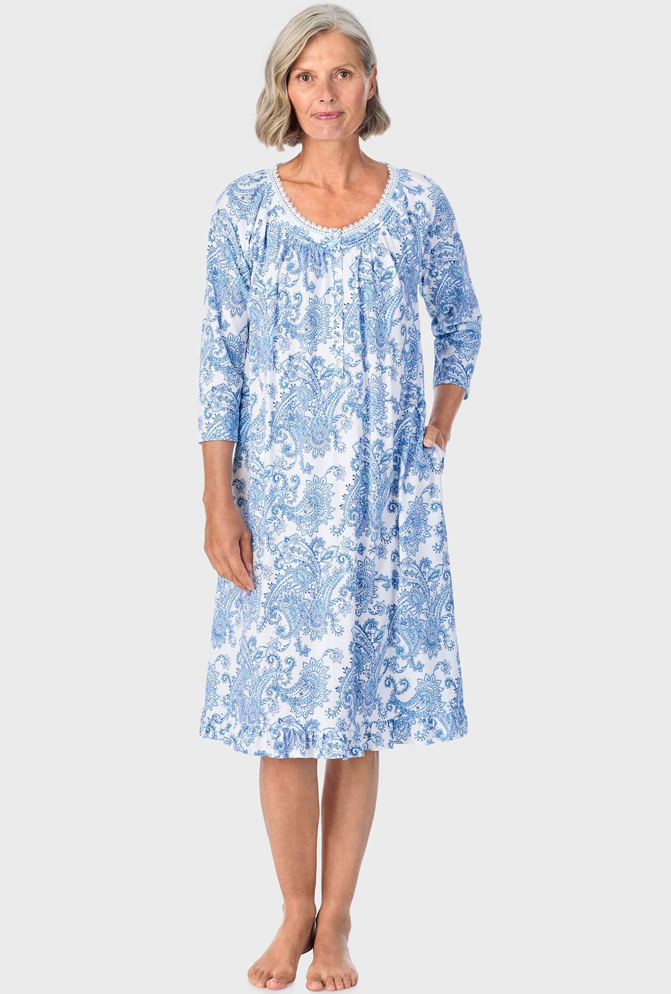 A lady wearing blue quarter sleeve nightgown with cool multi paisley print.