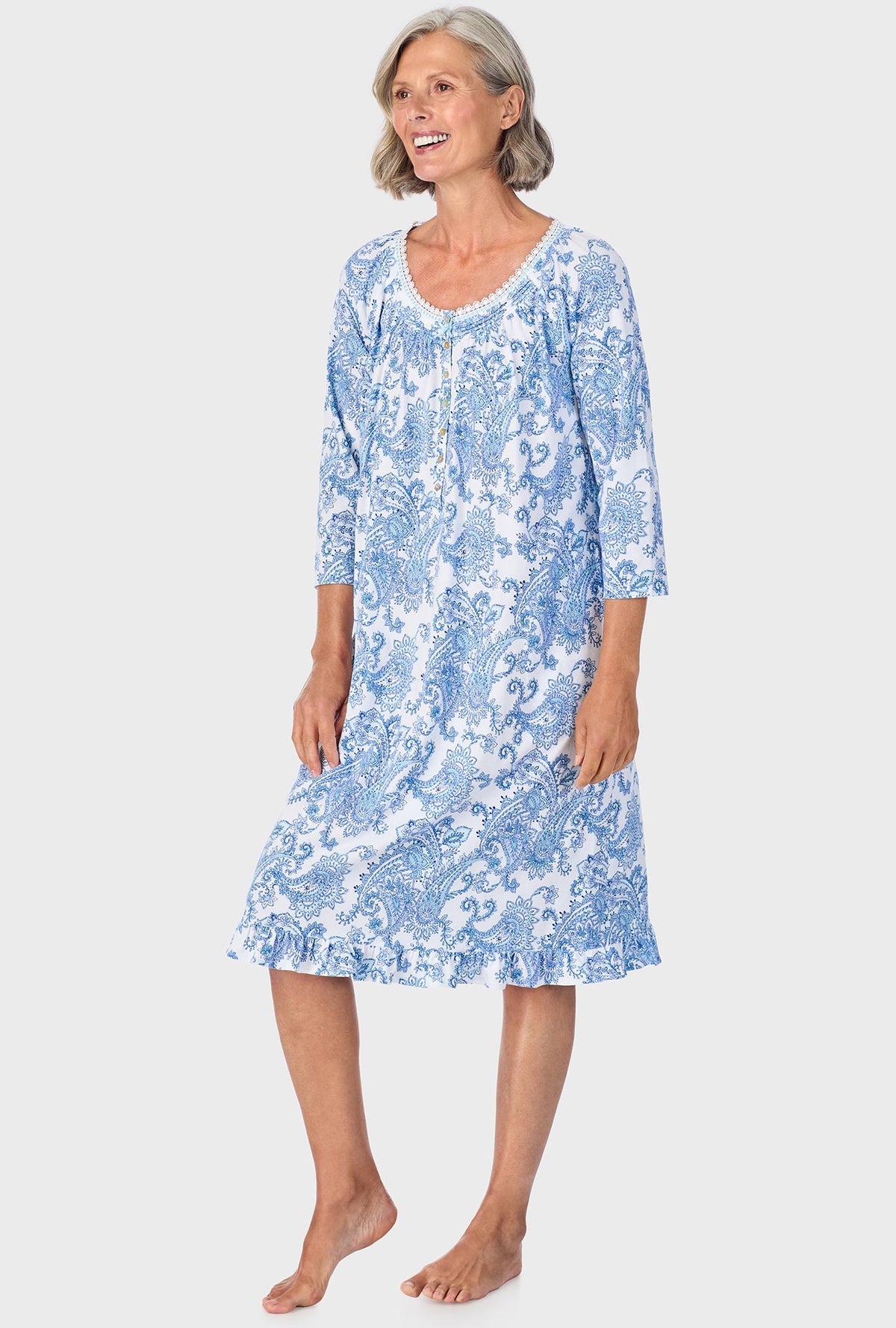 A lady wearing blue quarter sleeve nightgown with cool multi paisley print.