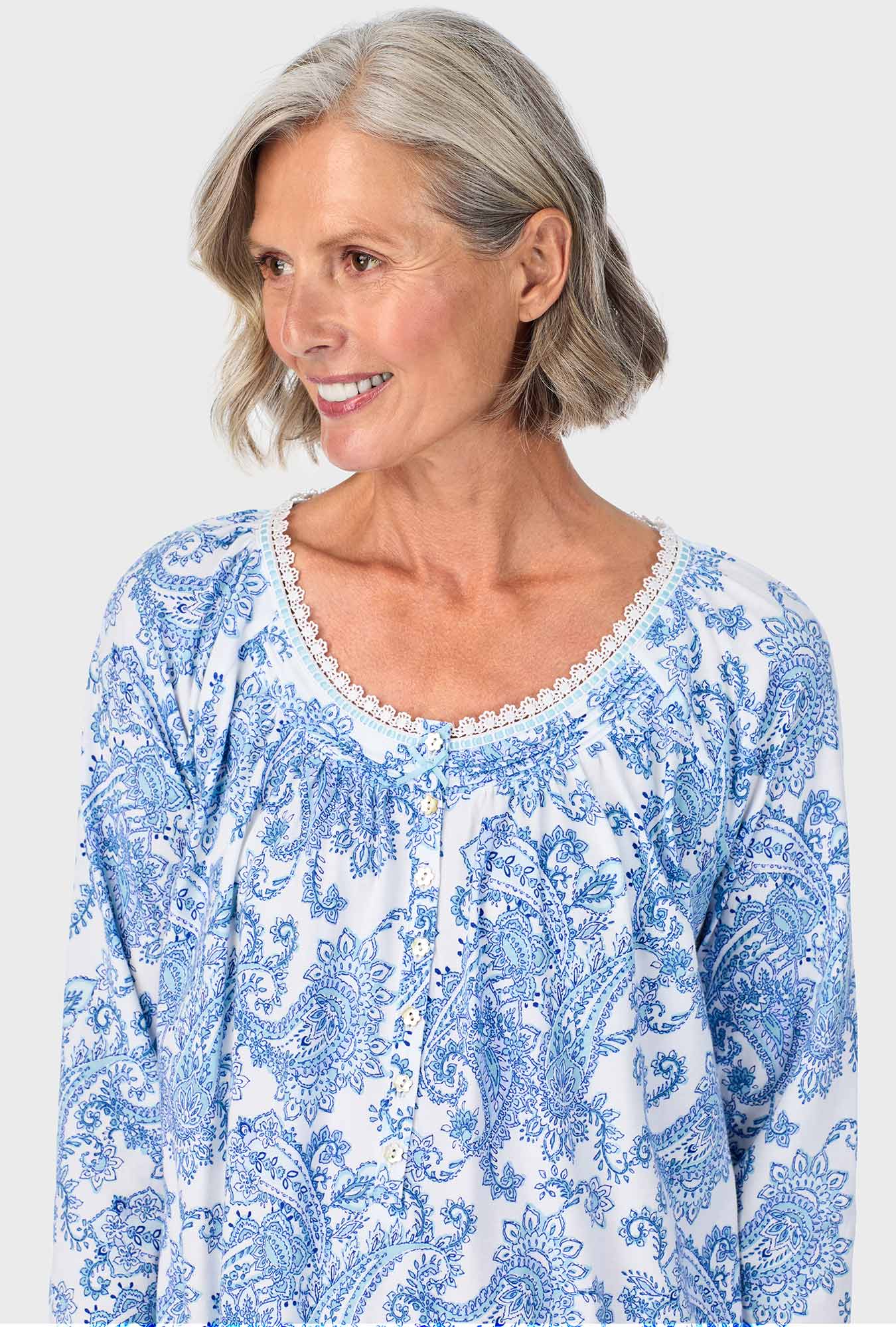 A lady wearing blue quarter sleeve nightgown with cool multi paisley print.