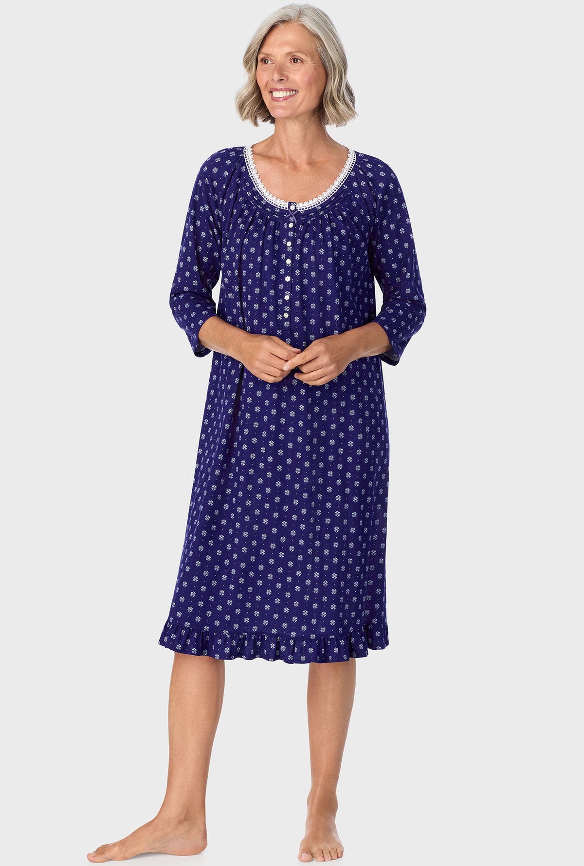 A lady wearing navy quarter sleeve nightgown with navy geo print.